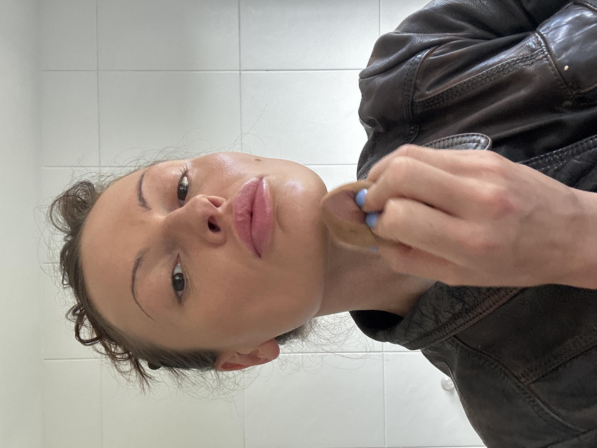 Woman applies makeup in Tunbridge Wells bathroom