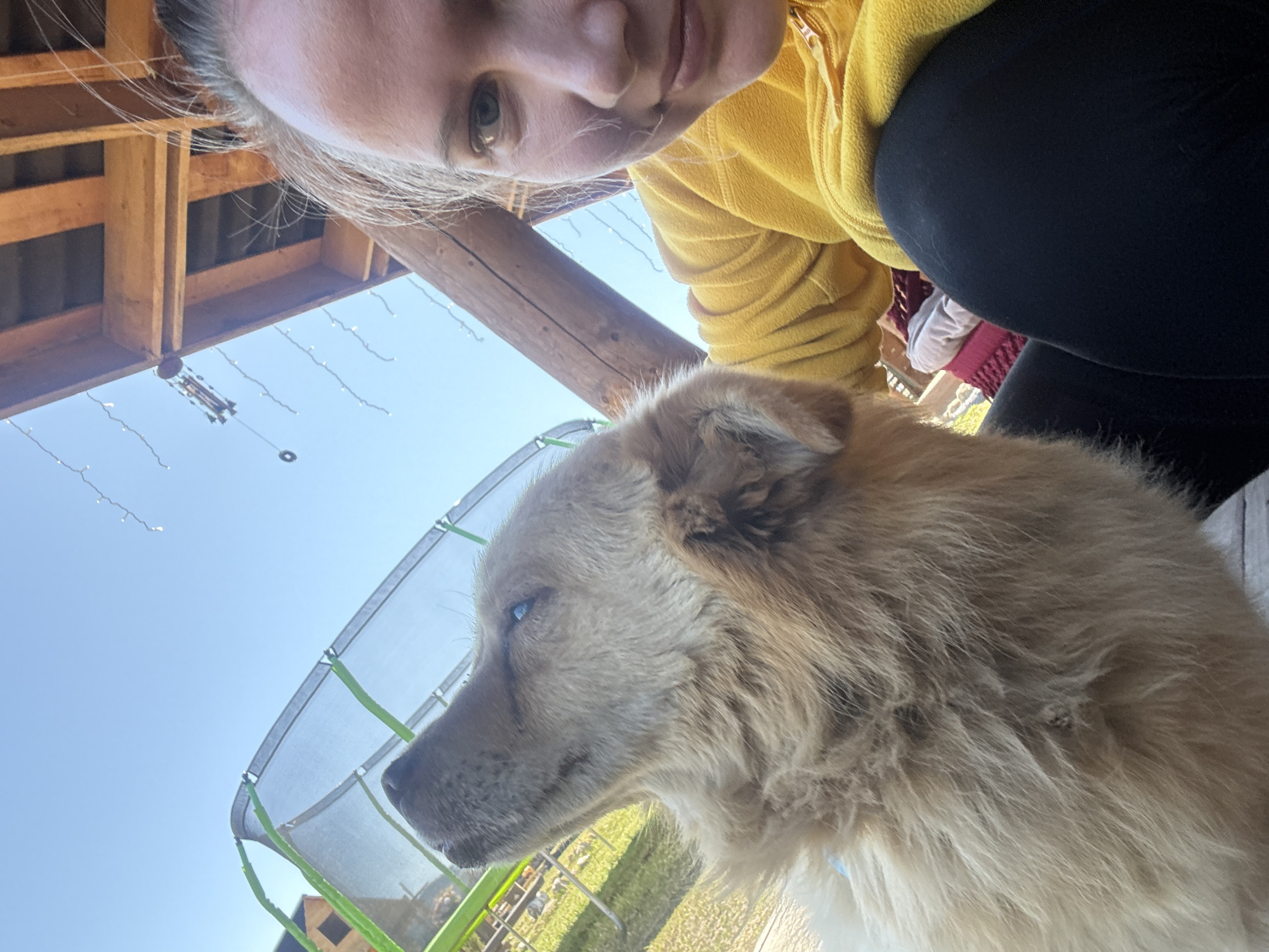 Woman photographs with dog in rural Russian town