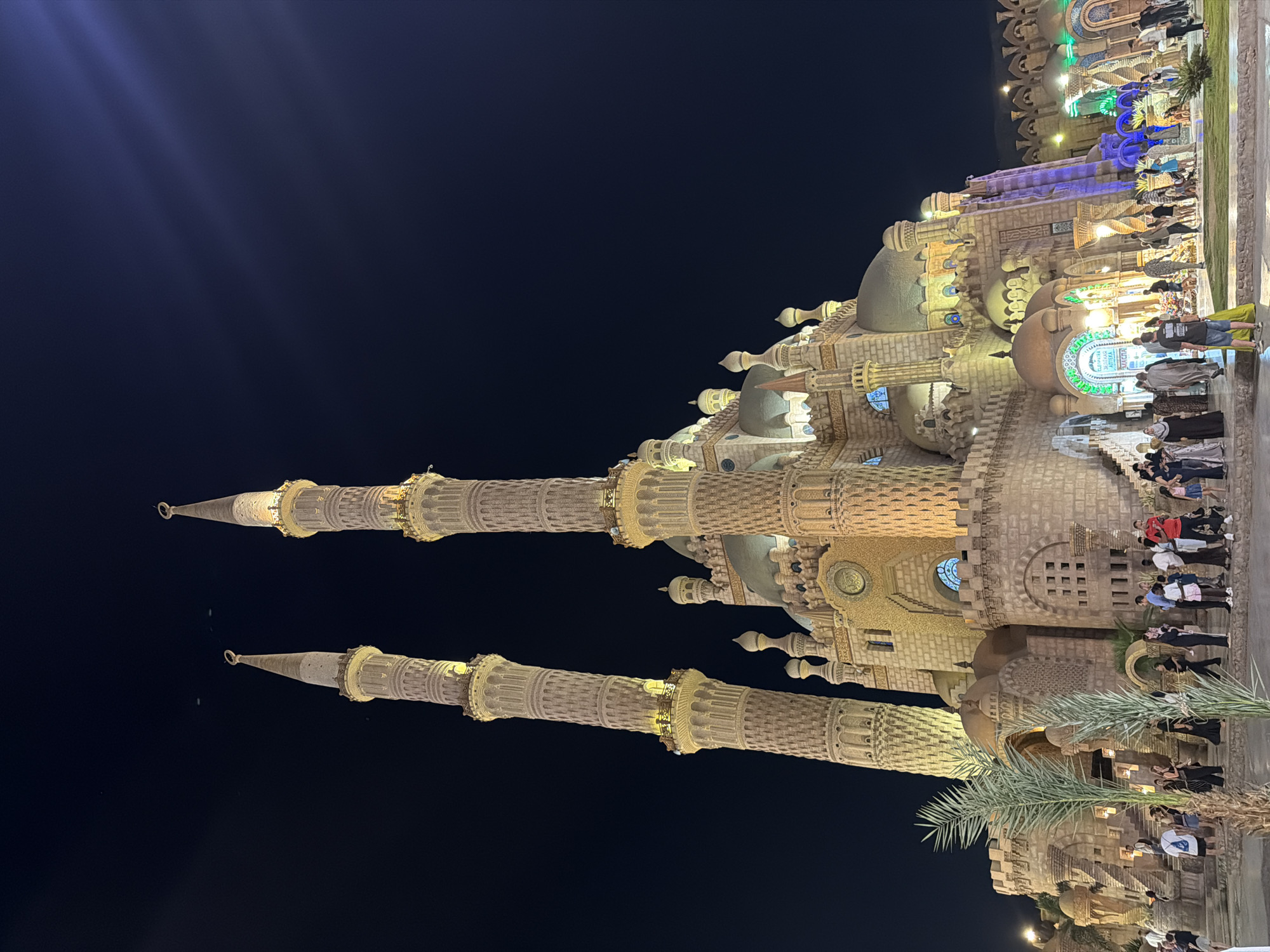 Al Sahaba Mosque glows over a bustling Sharm El Sheikh night scene