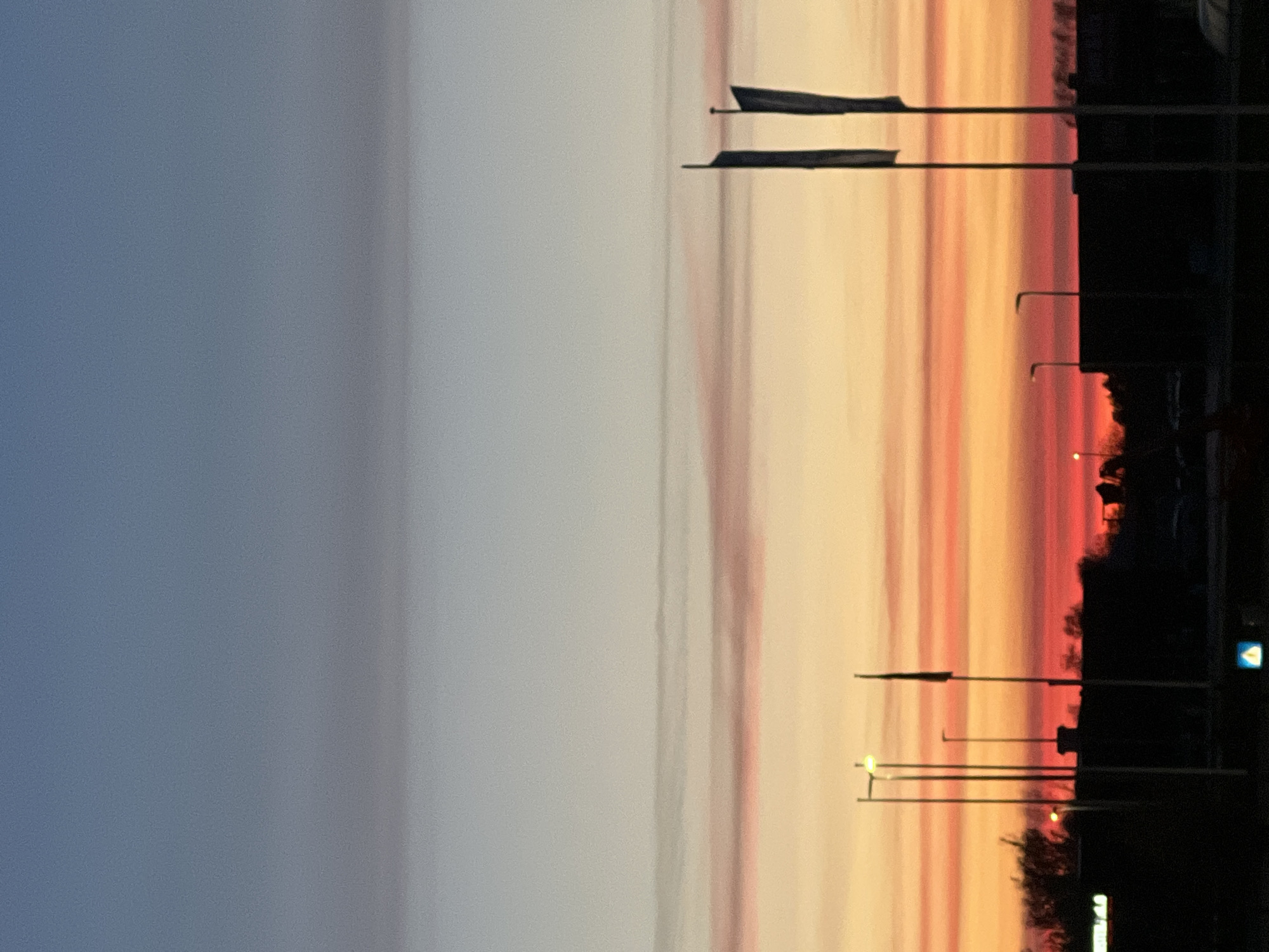 Dramatic sunset photographed over Aalborg streets during evening twilight