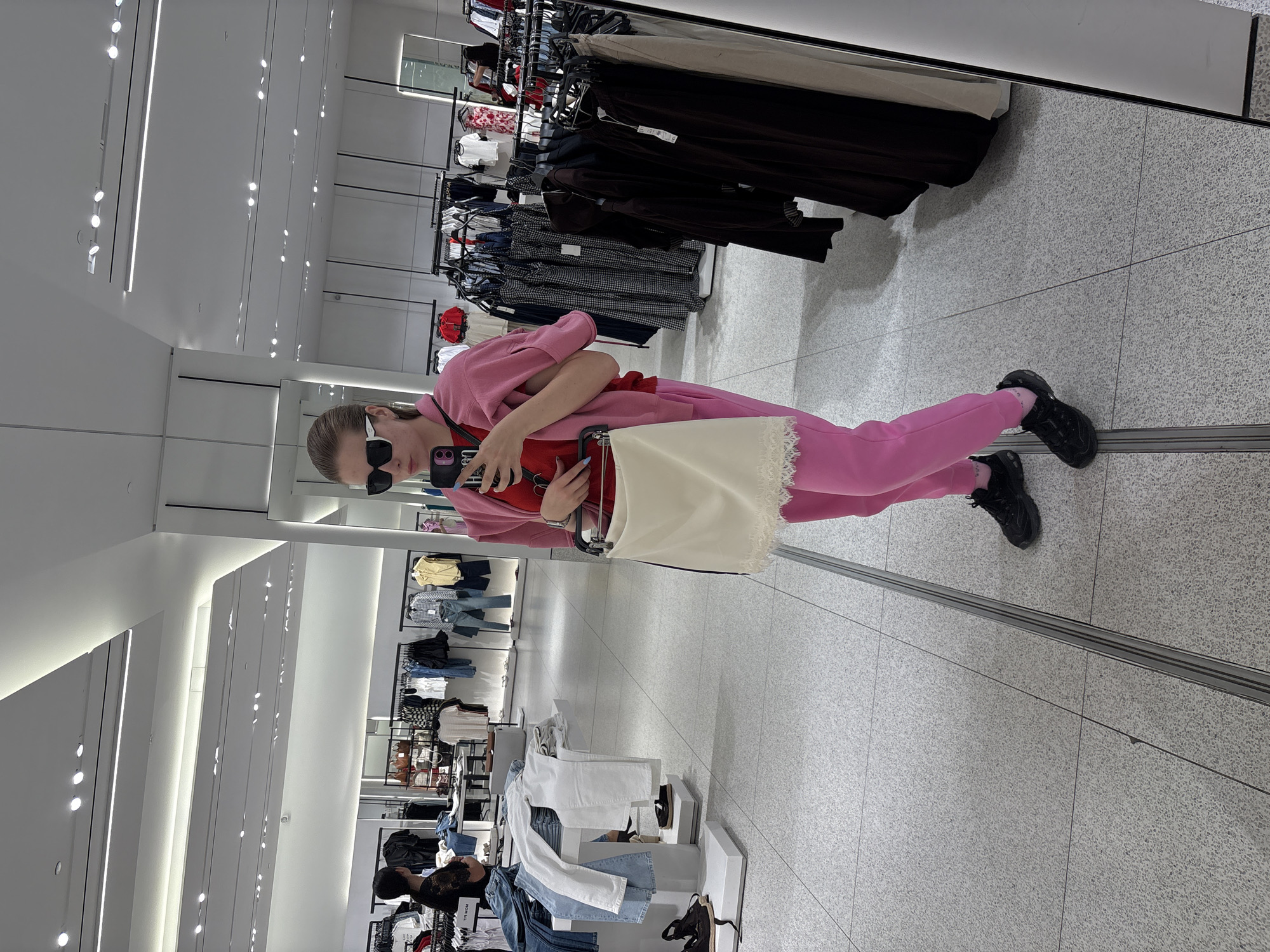 Shopper Takes Mirror Selfie in Plovdiv Clothing Store