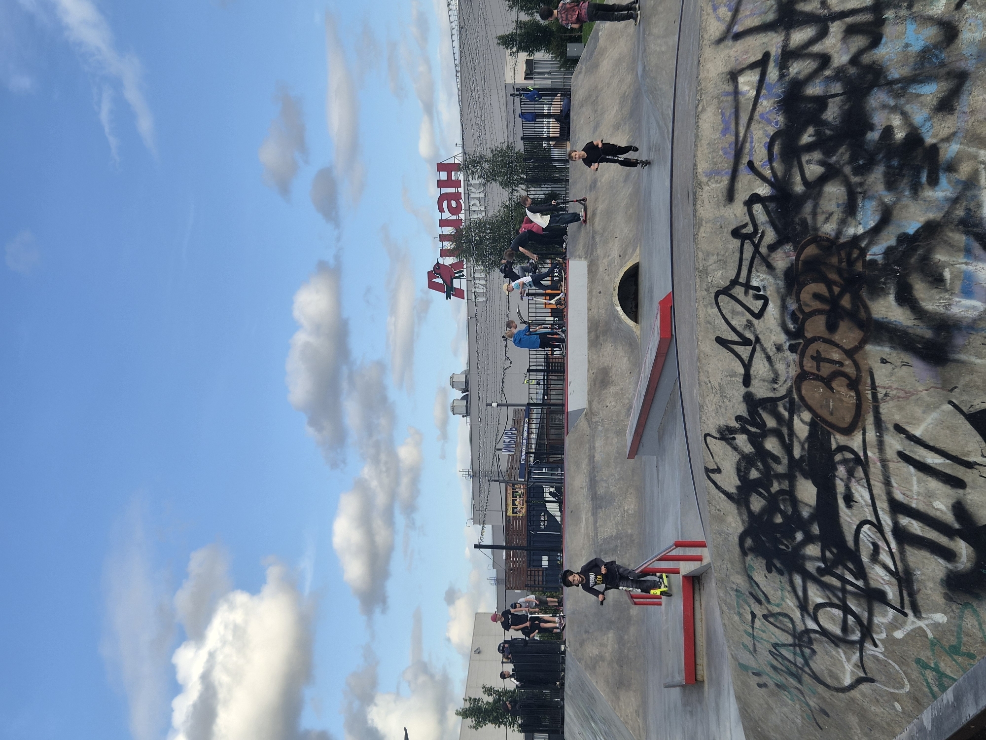 Afternoon session at a Kudrovo skatepark, scooters and concrete ramps