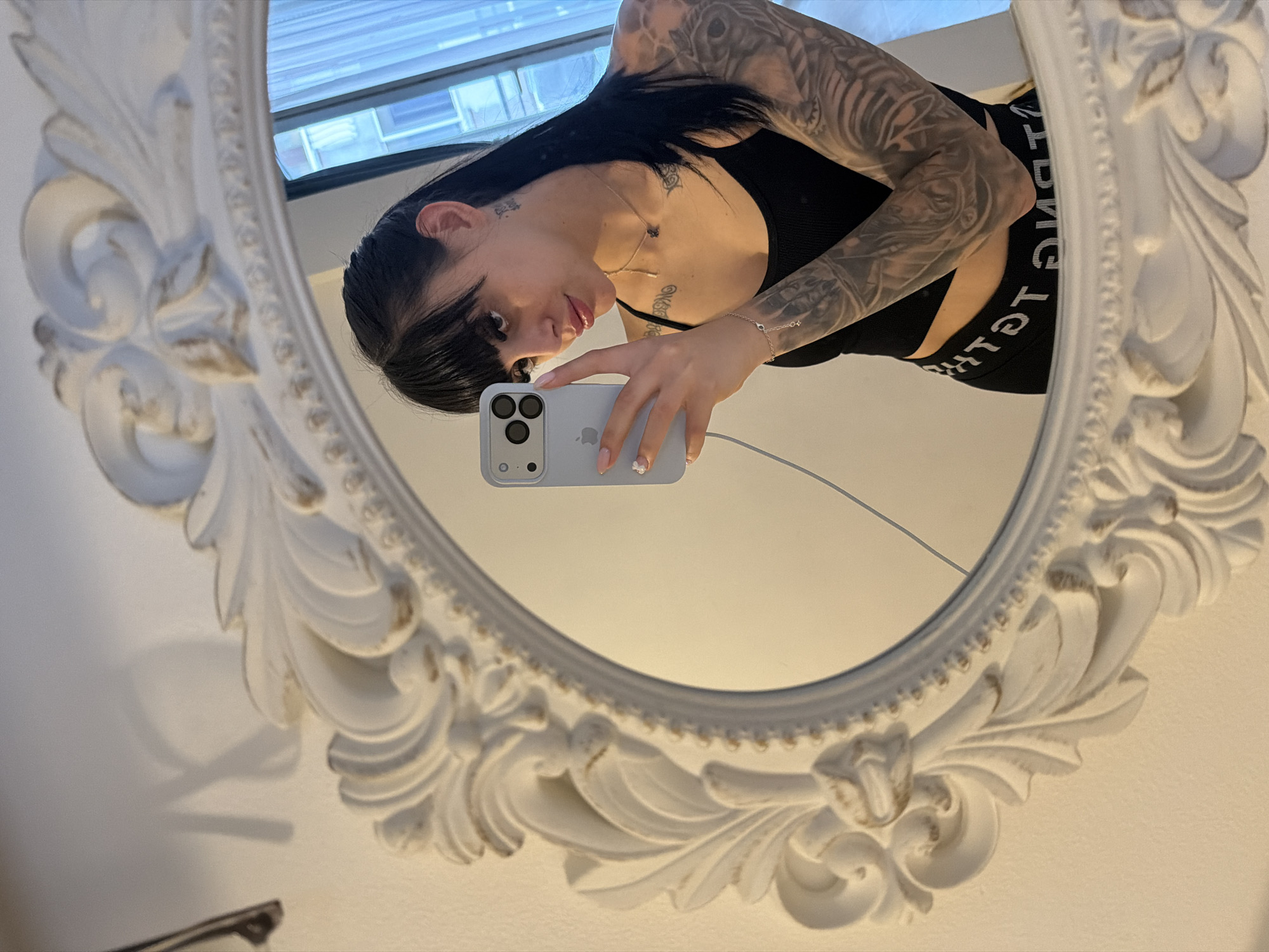 Tattooed woman takes mirror selfie in Plovdiv