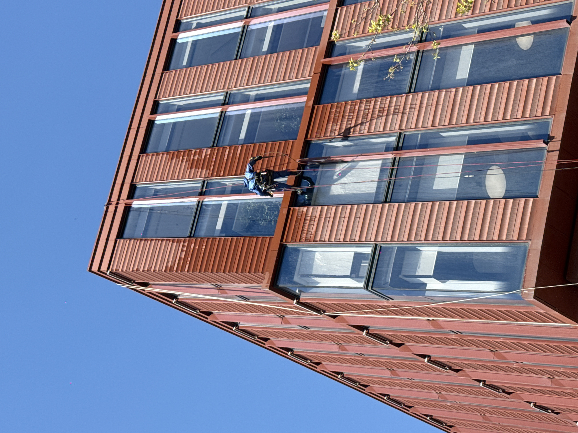 Window washer cleans high-rise building facade in Khimki, Russia