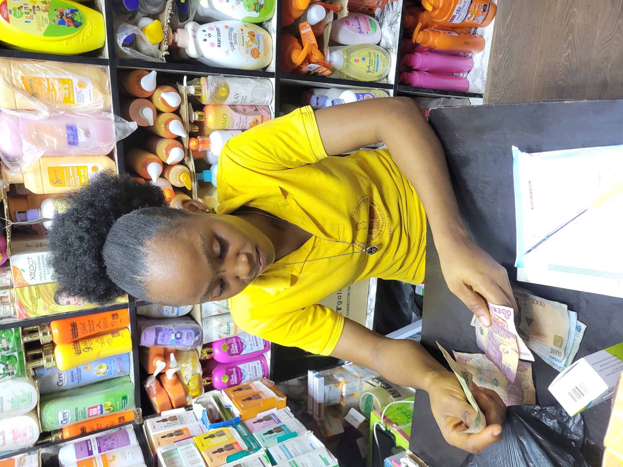 Woman operates beauty shop in Onitsha during busy afternoon