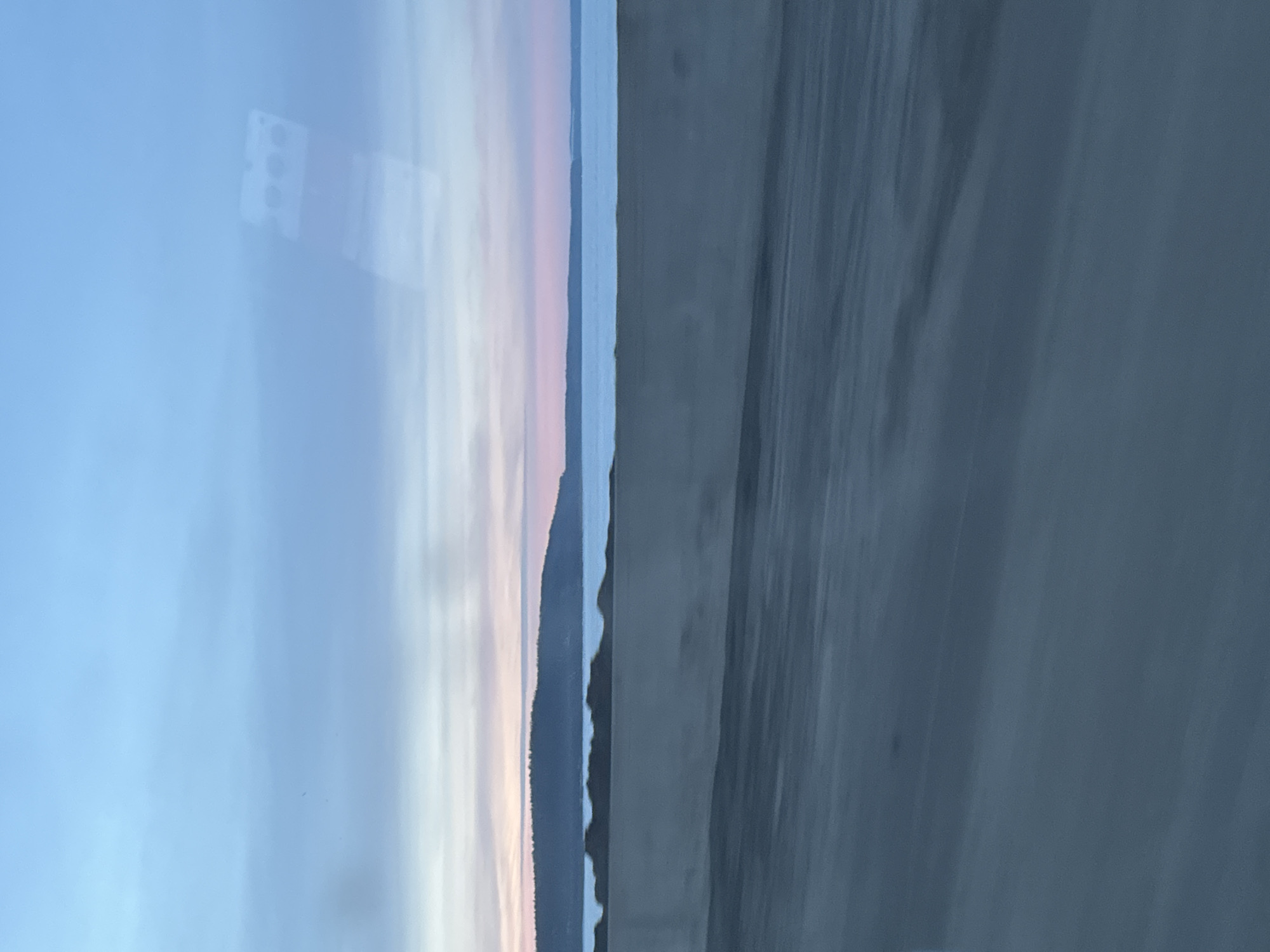 Vehicle journey past Votkinsk Reservoir captured during twilight in Chaikovsky