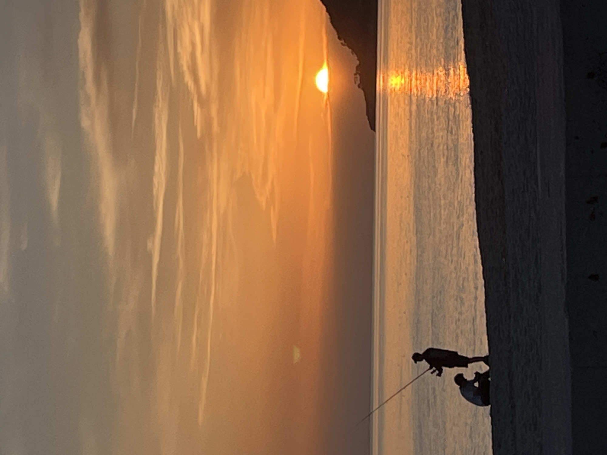 Sunset watchers gather on Alanya beach during golden hour