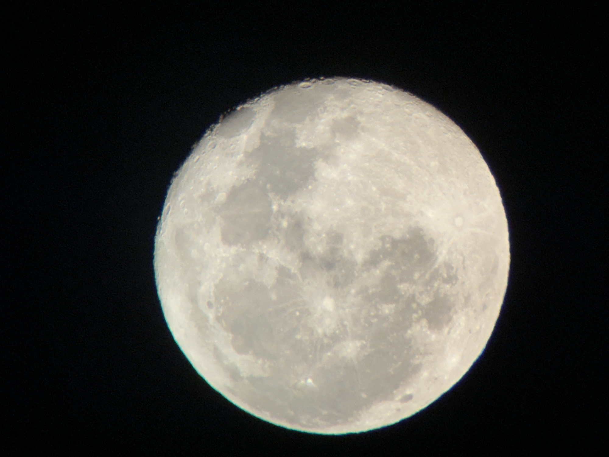 Moon photographed two ways over Târgu Neamț on a summer evening