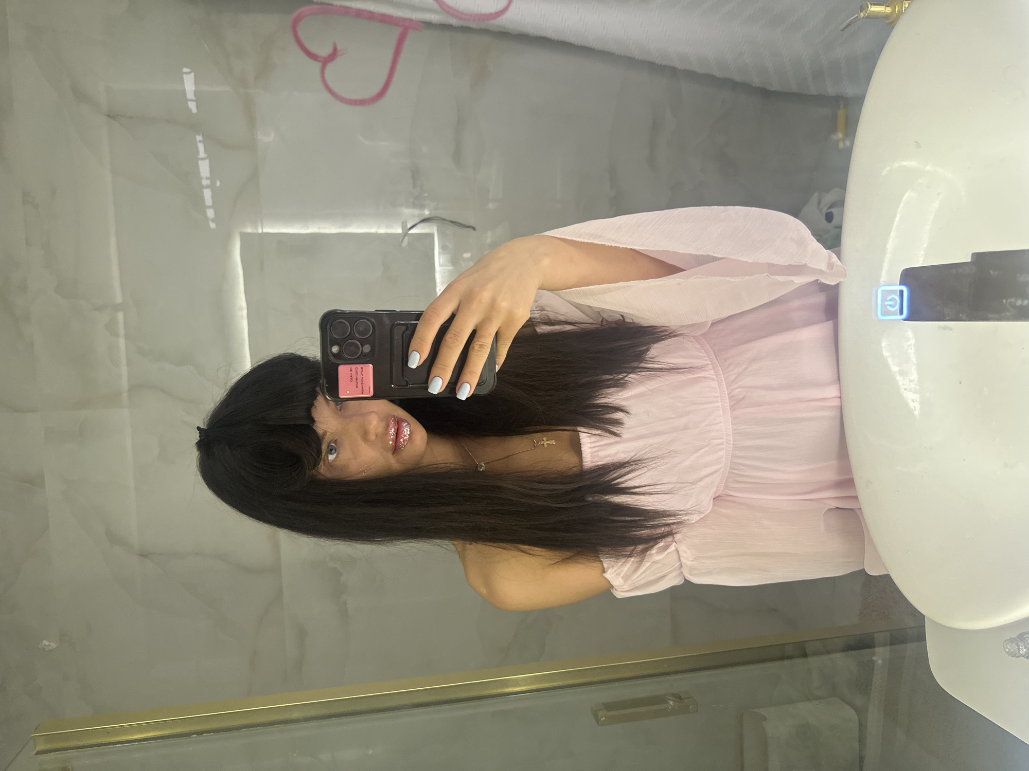 Woman takes mirror selfie in light pink outfit, Moscow