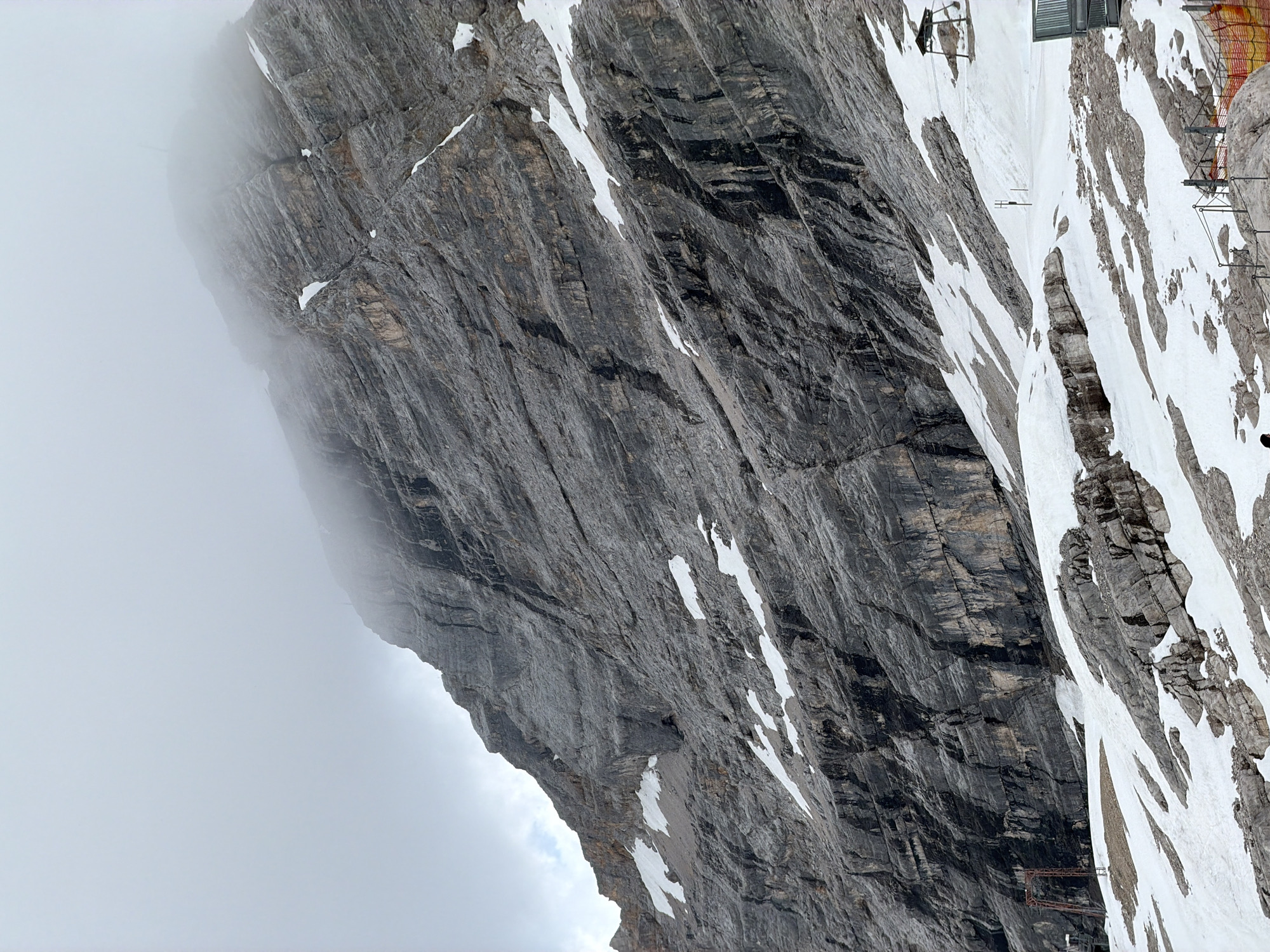 Visitors document Zugspitze alpine views during overcast afternoon