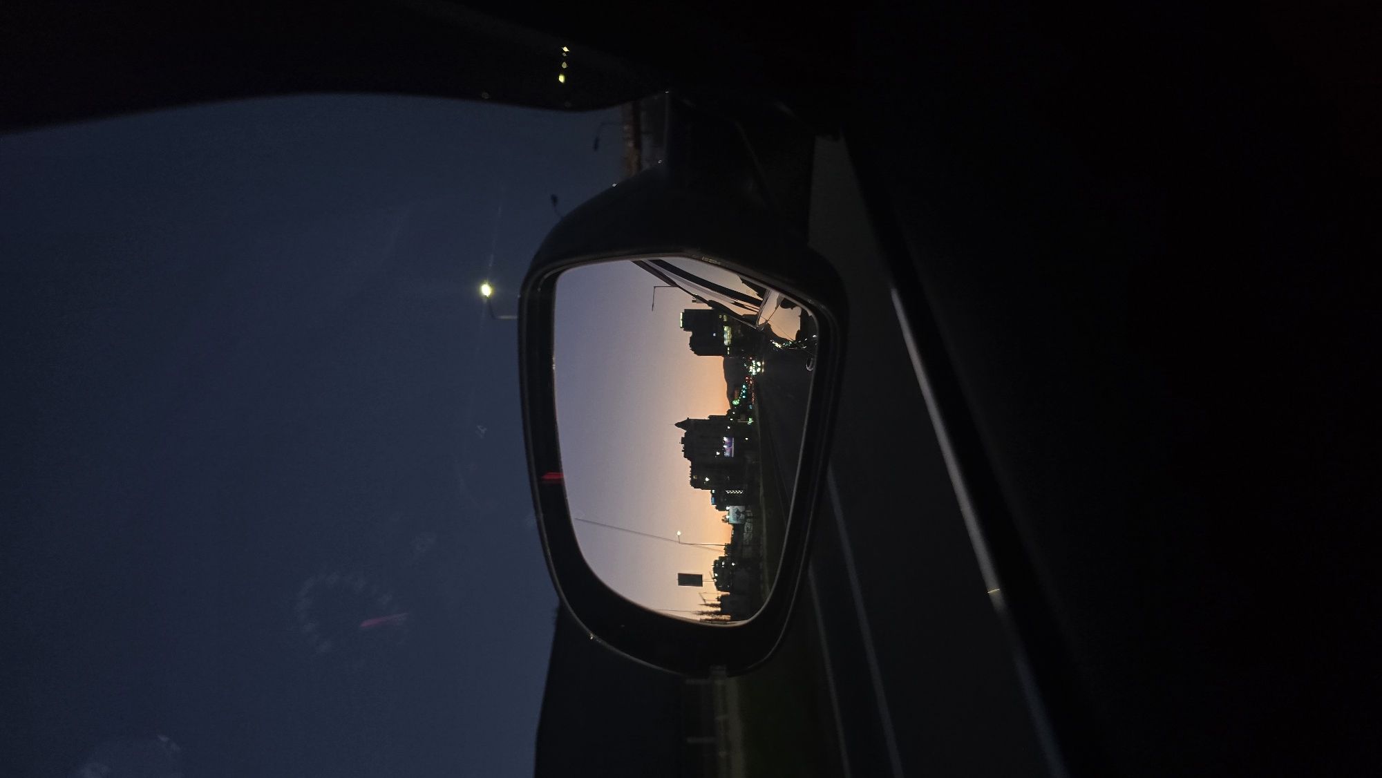 Evening cityscape reflected in car mirror, Sofia Bulgaria