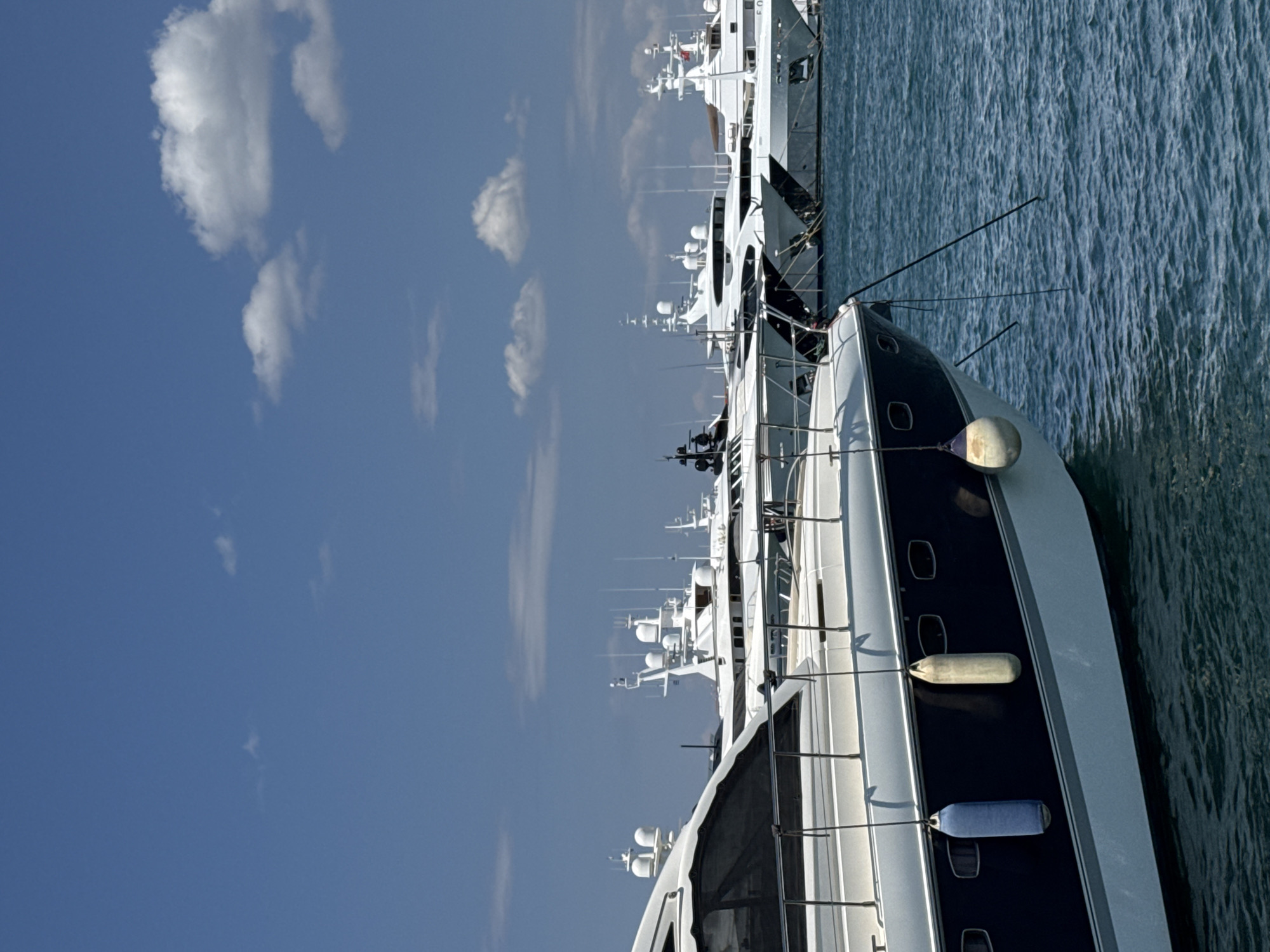 Luxury yachts lined up at a sunny Moschato marina