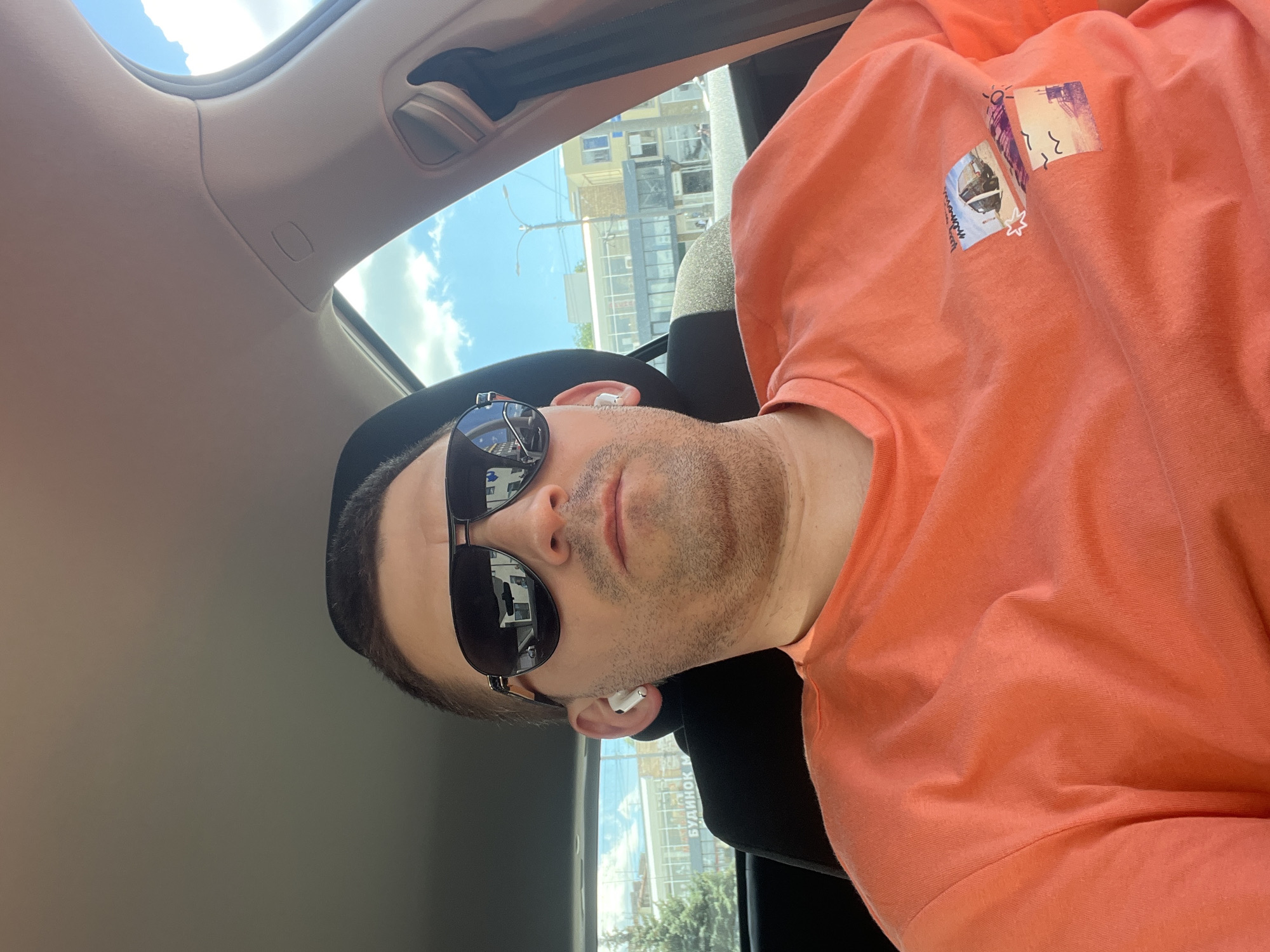 Orange shirt, earbuds, and energy drinks in Kharkiv