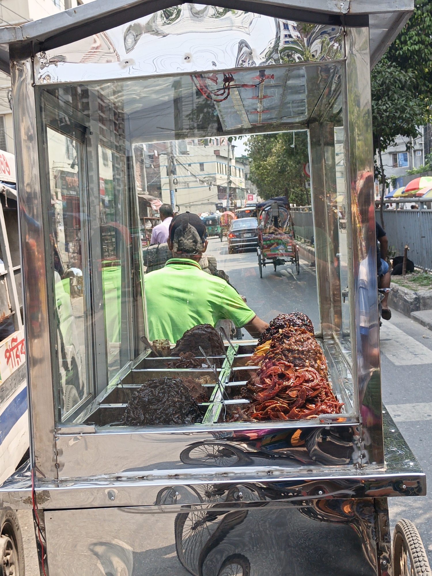 Street vendors operate mobile carts in morning Dhaka traffic