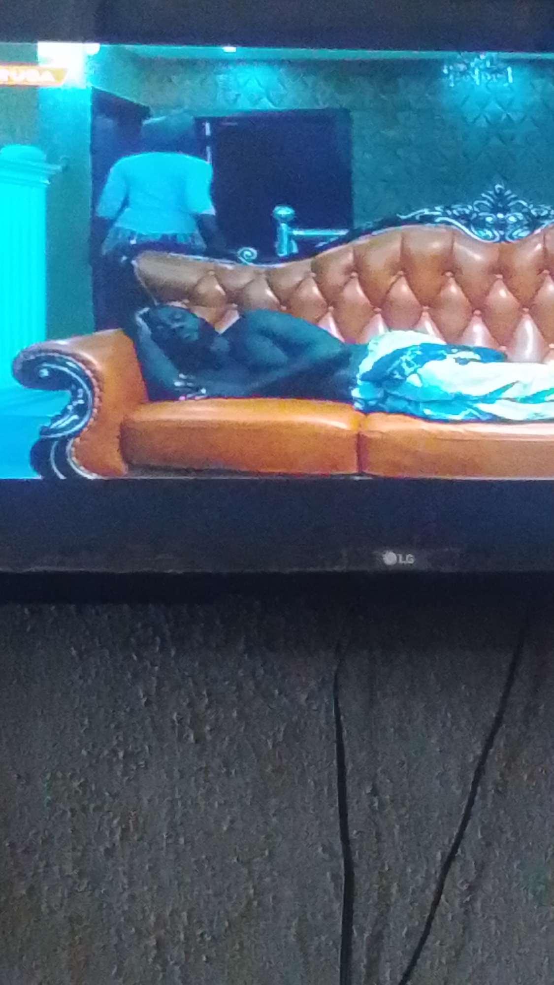Nigerian viewer watches mixed TV programming in Lokoja morning session