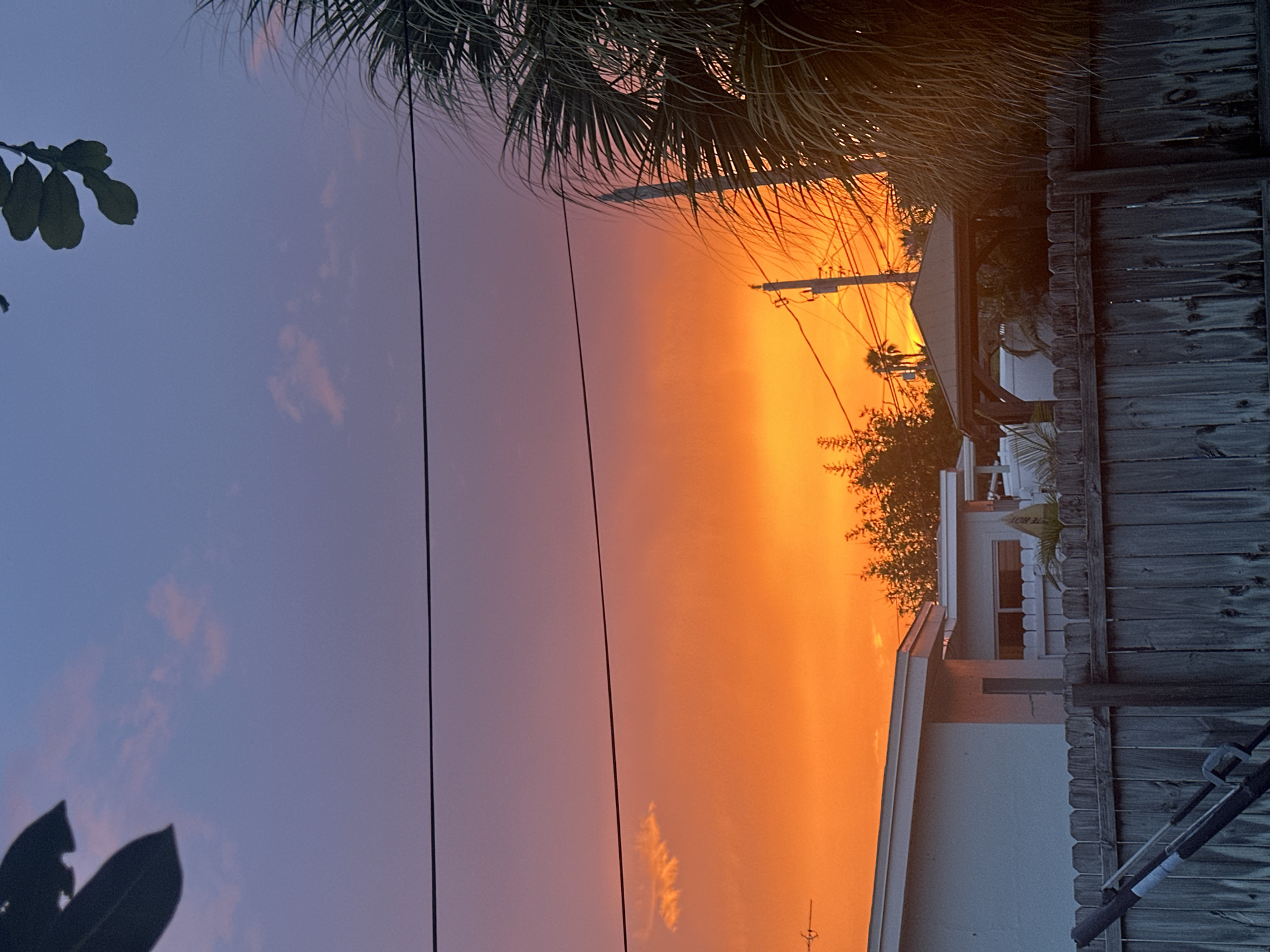 Vivid purple-to-orange sunset over Indian Harbour Beach residential streets