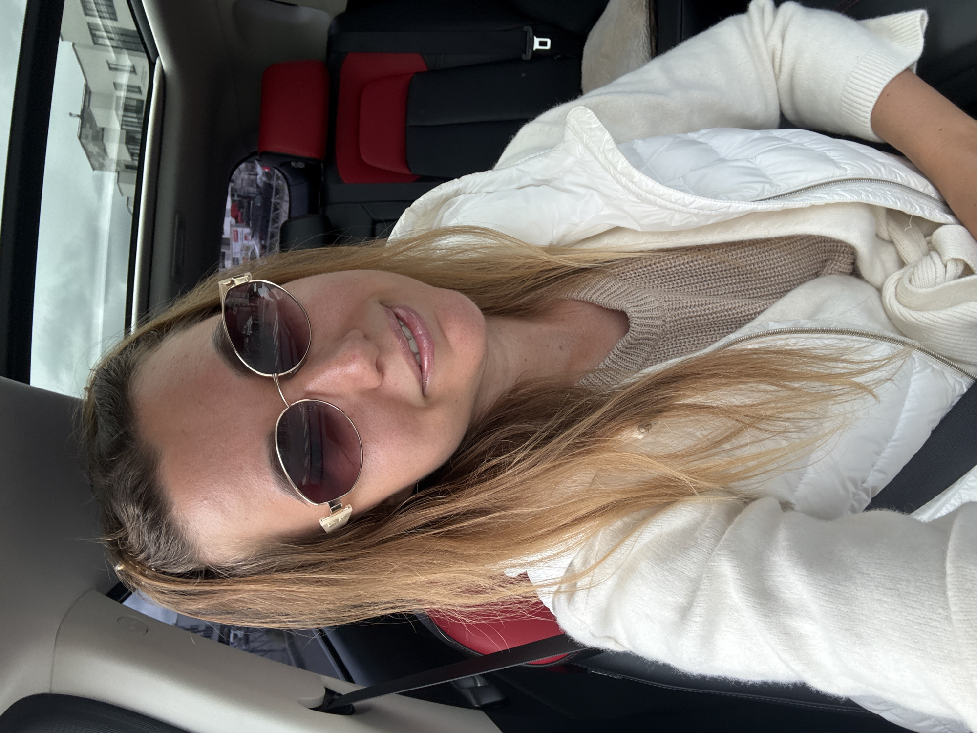 Woman takes selfies in passenger seat during car ride