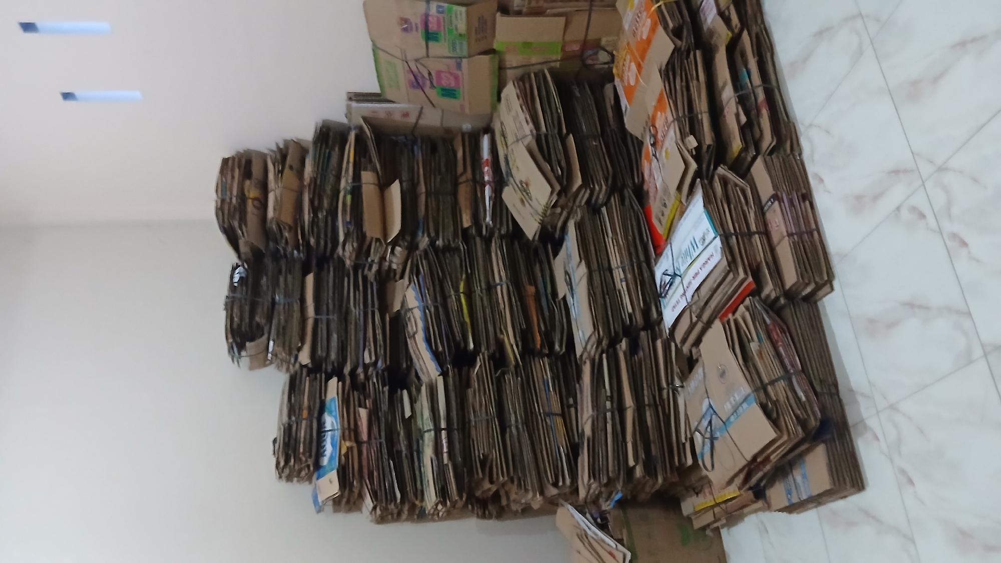 Cardboard boxes bundled for recycling in Lhokseumawe facility