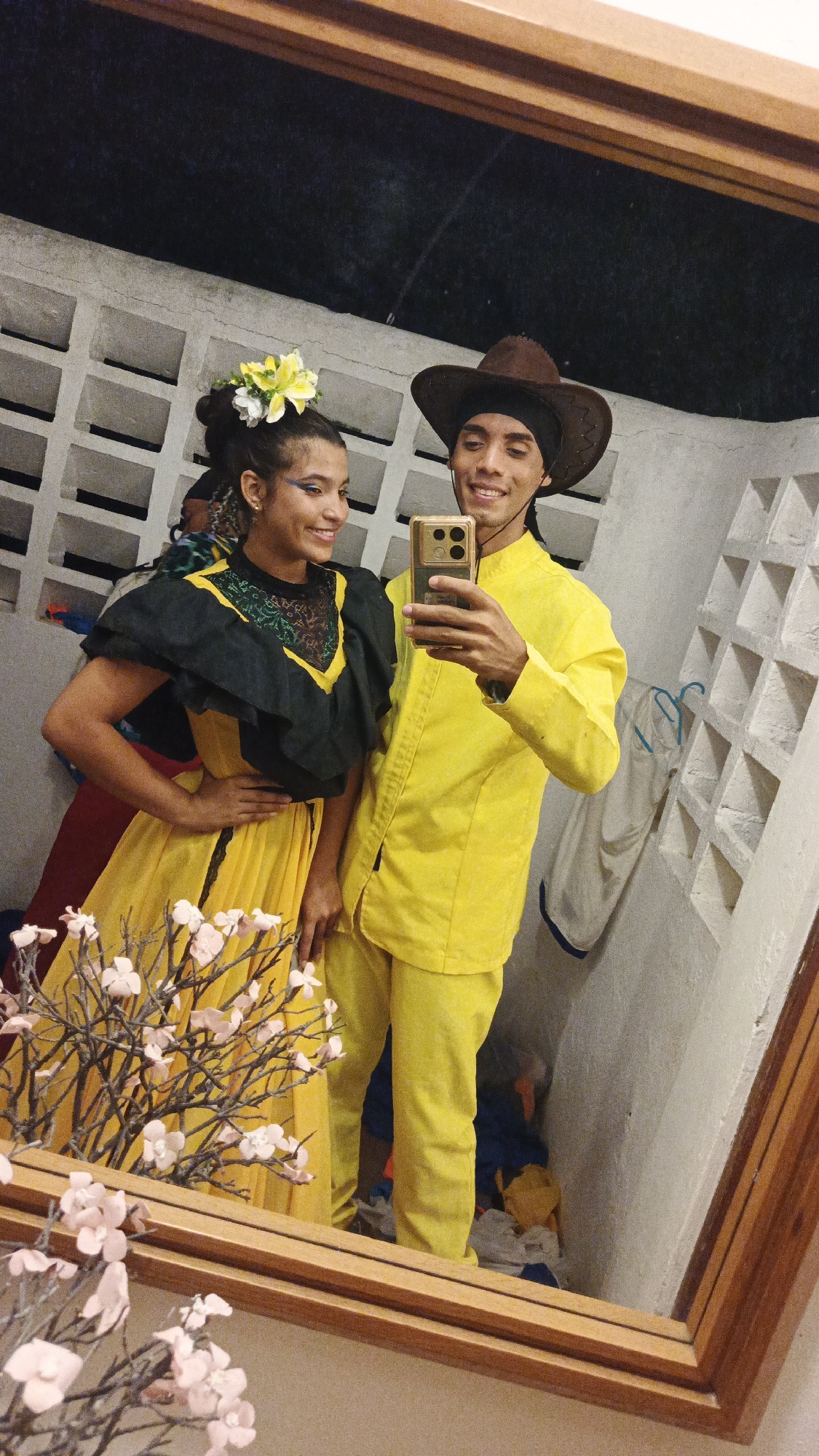 Two people take selfie in traditional dress, Venezuela