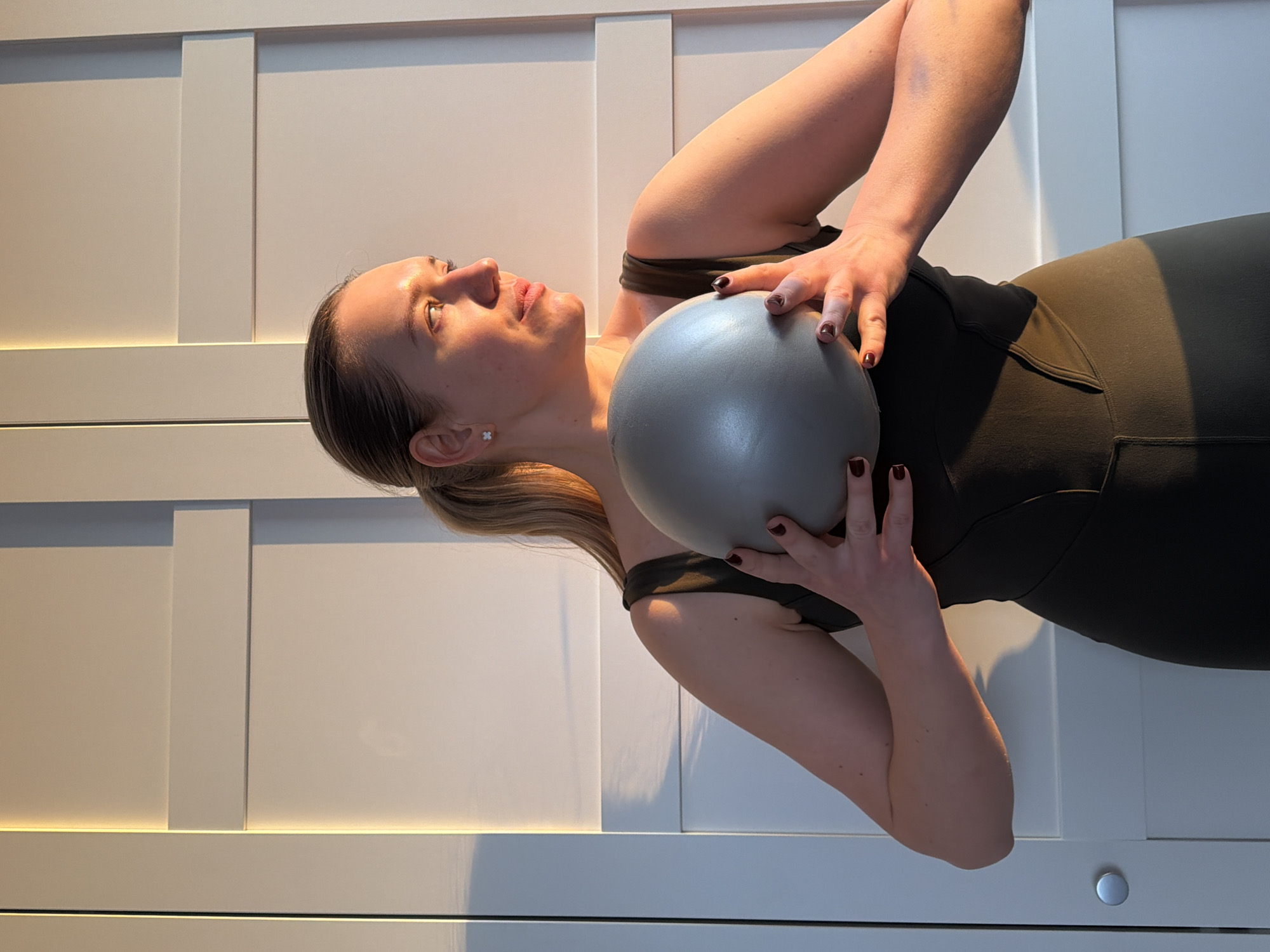 Woman exercises with ball in Dreiliņi, Latvia