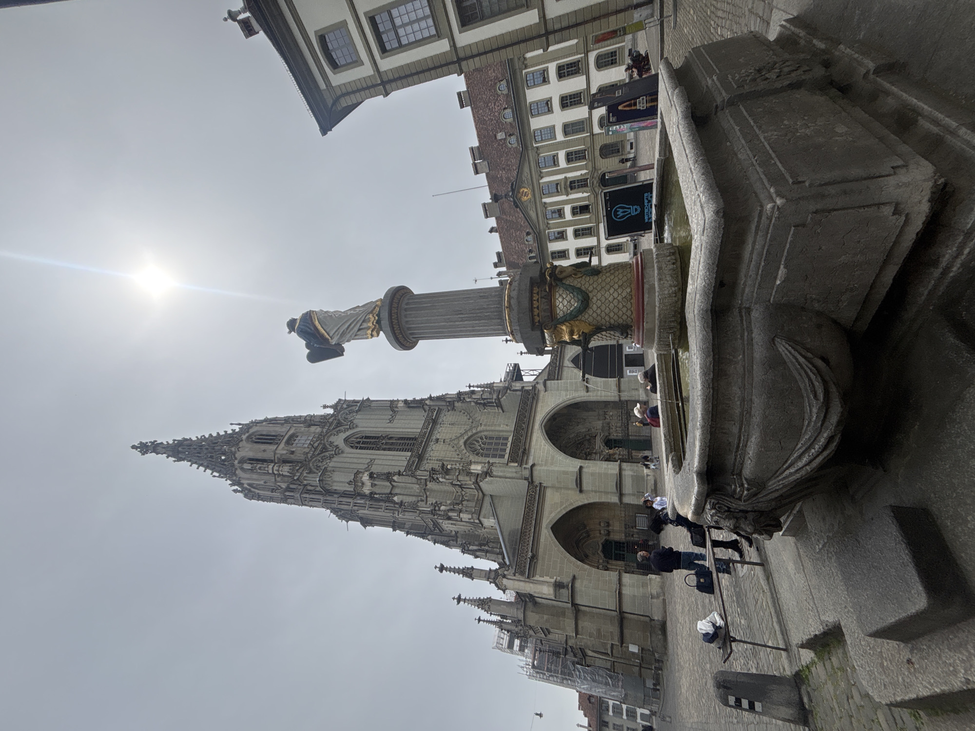 Tourist captures Bern's historic landmarks during morning walking tour