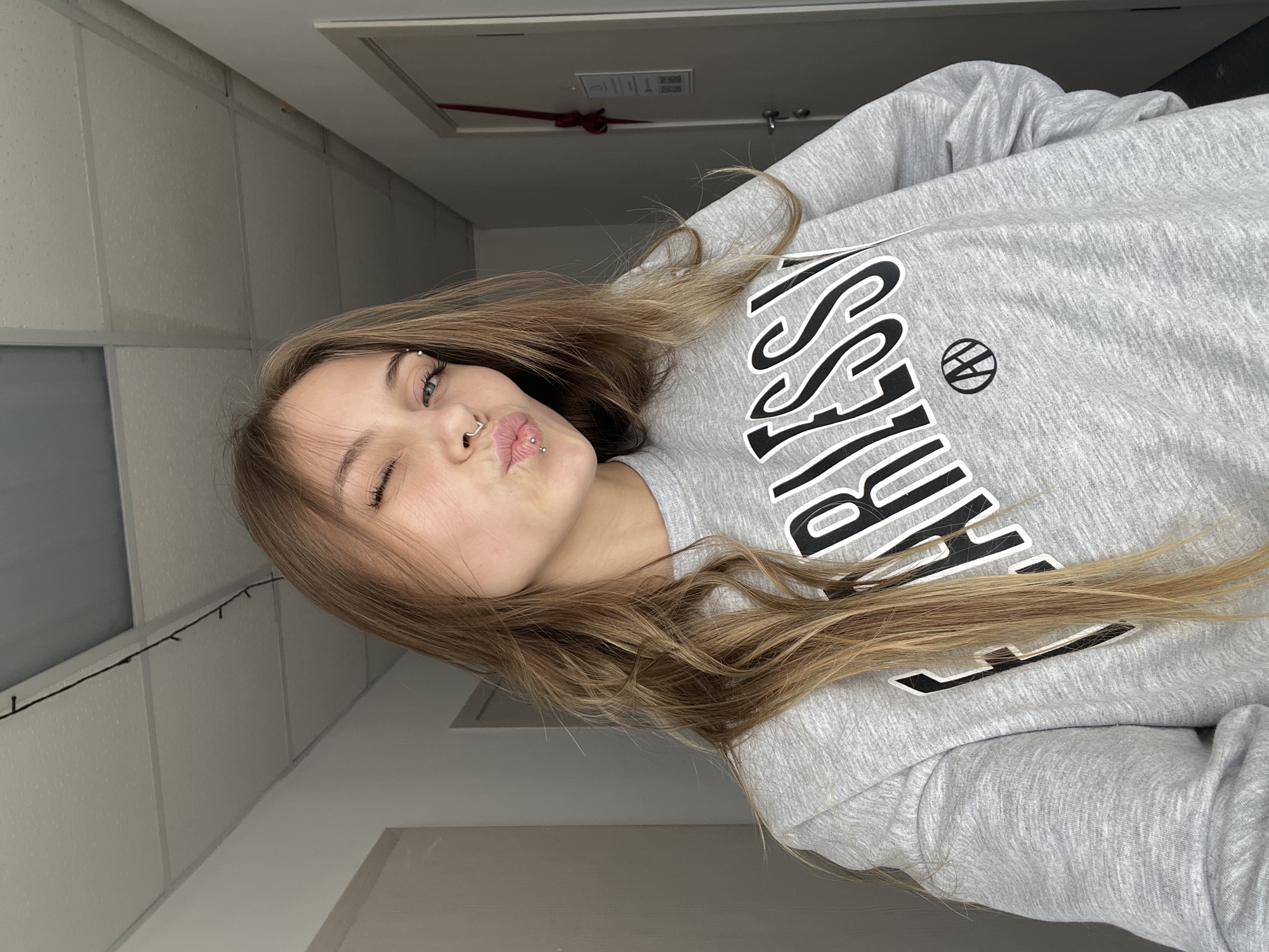 Woman takes selfies in grey sweatshirt in Фоки, Russia