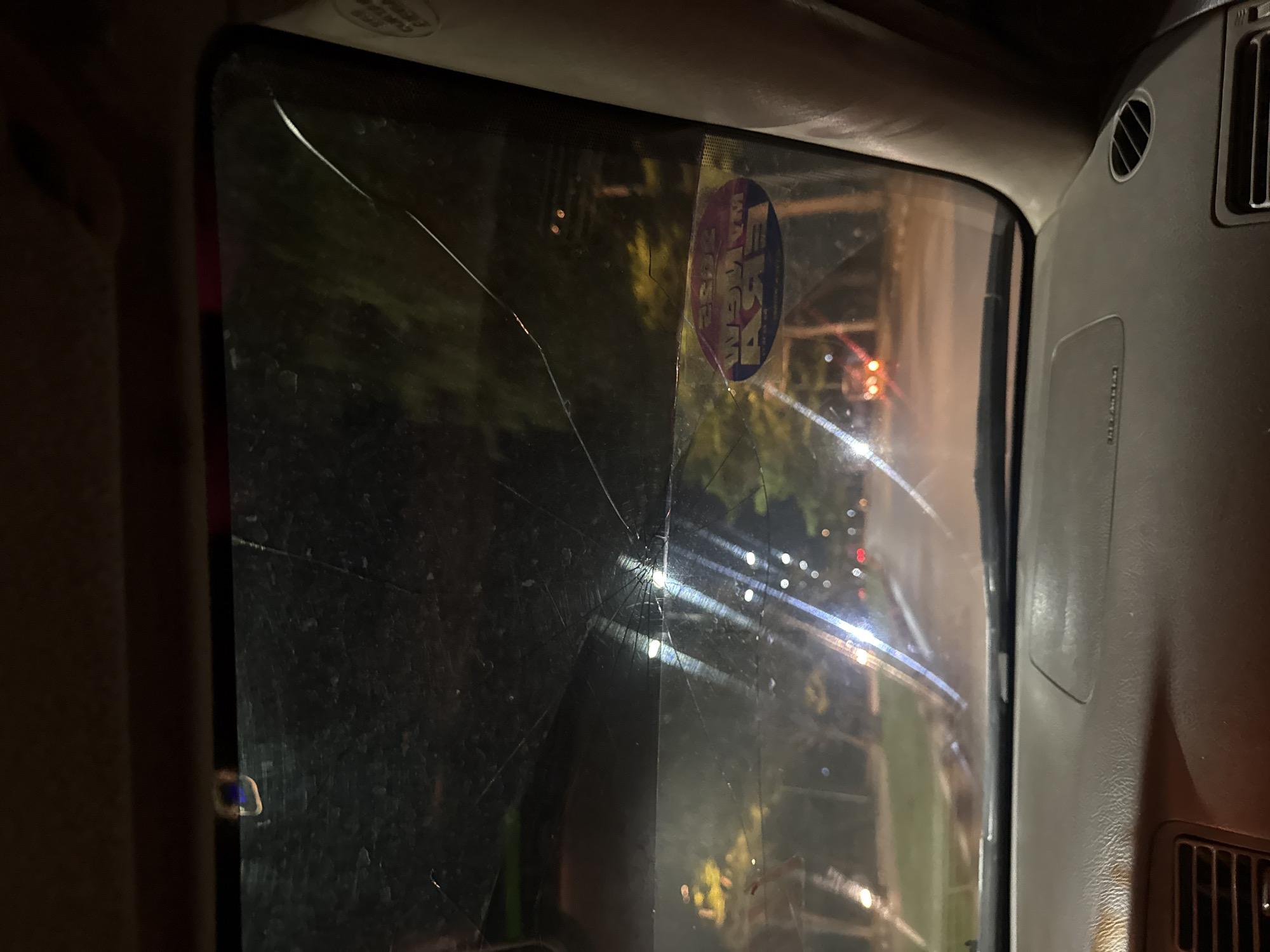 Vehicle windshield cracked during evening hours in Abuja