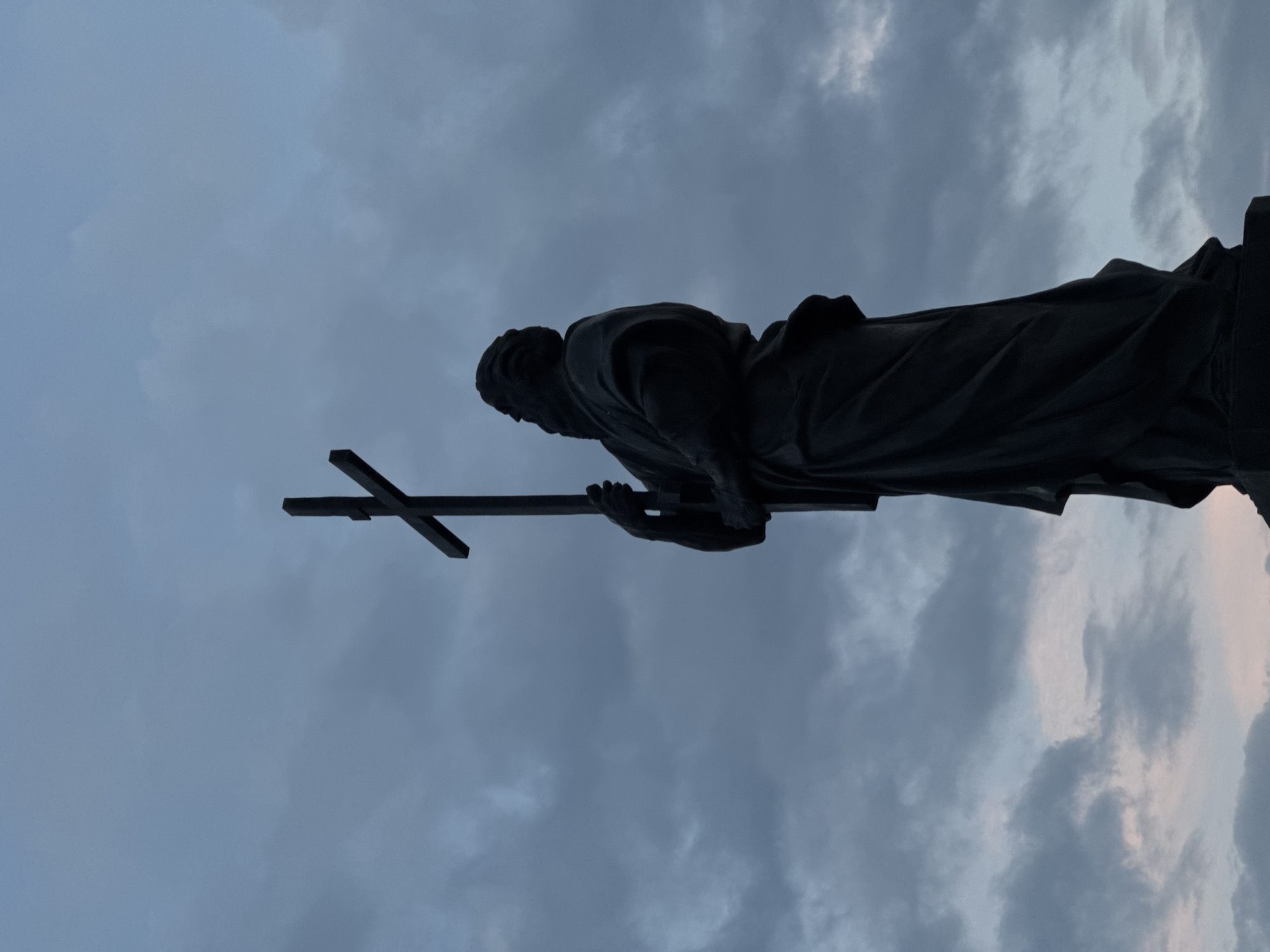 Holy Trinity Church and cross-bearing statue photographed in Bataysk