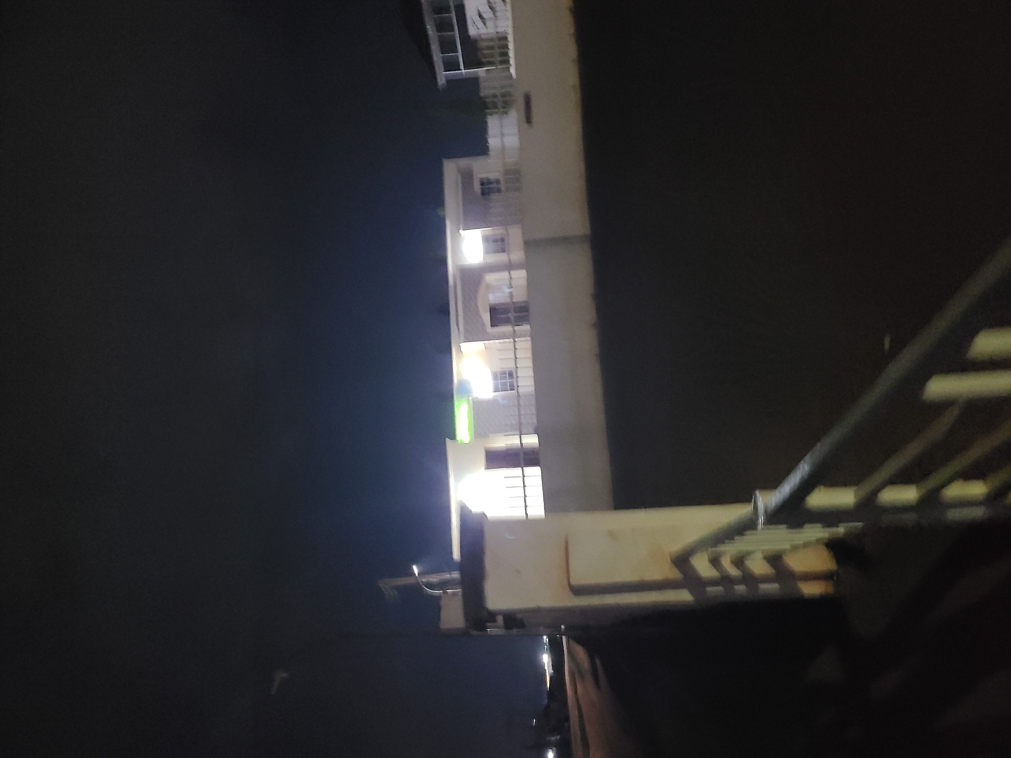 Nighttime street scenes from a wet Abuja road