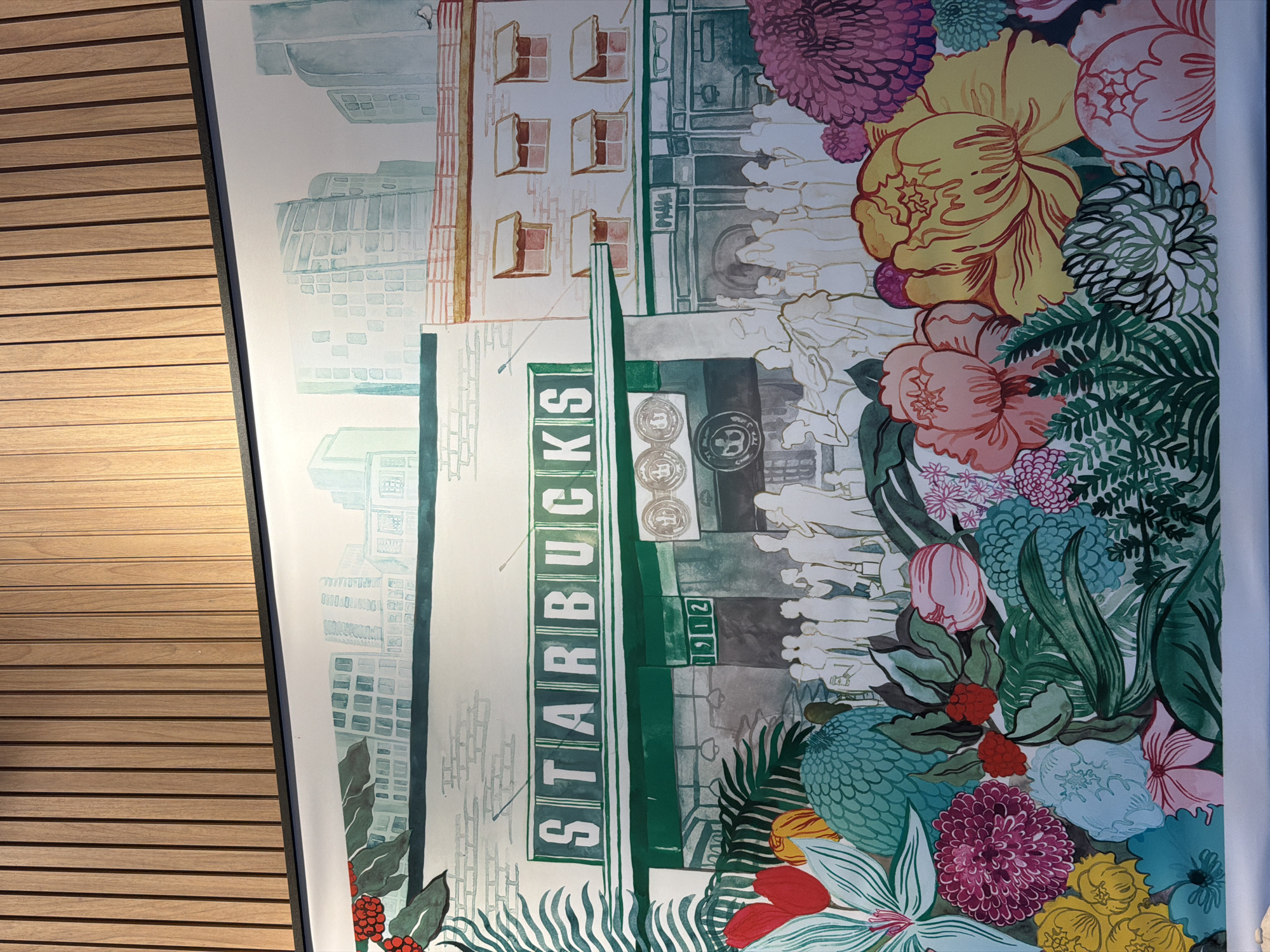 Starbucks interior with historical mural, modern lighting documented in Brasília