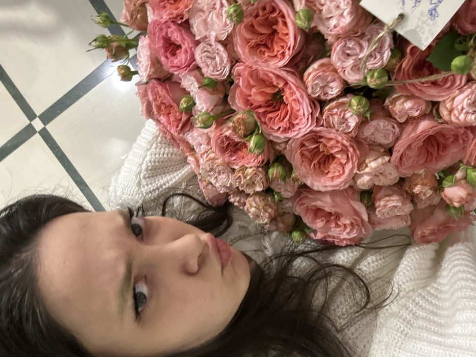 Woman poses with roses, stuffed animal in Yerevan morning