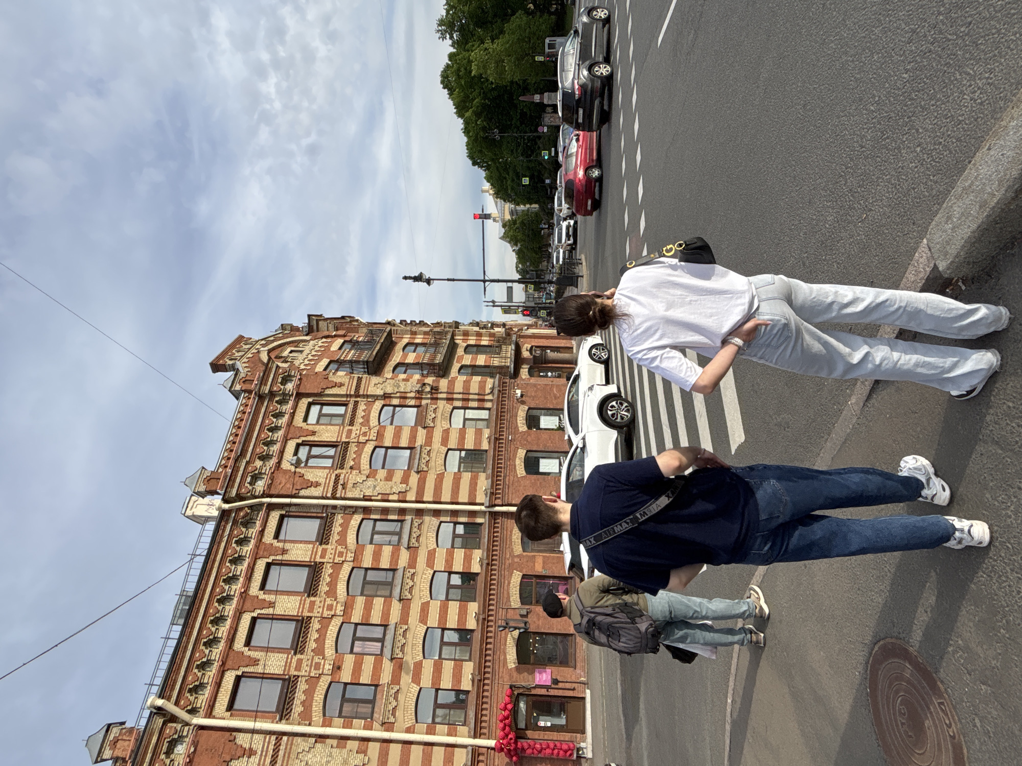 Tourists and pedestrians explore central Saint Petersburg on sunny afternoon