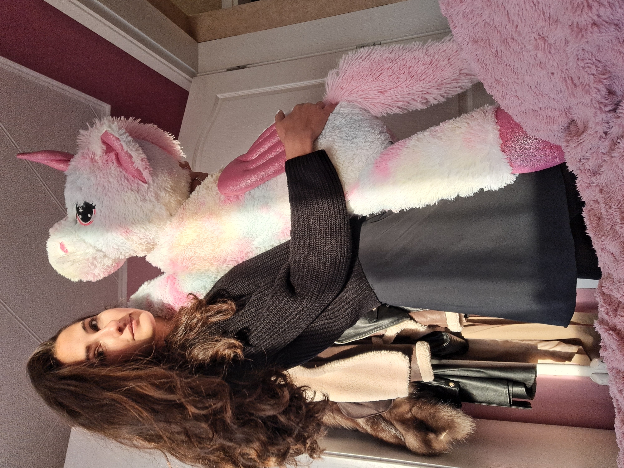 Woman photographed with plush unicorn toy in Chepintsi, Bulgaria