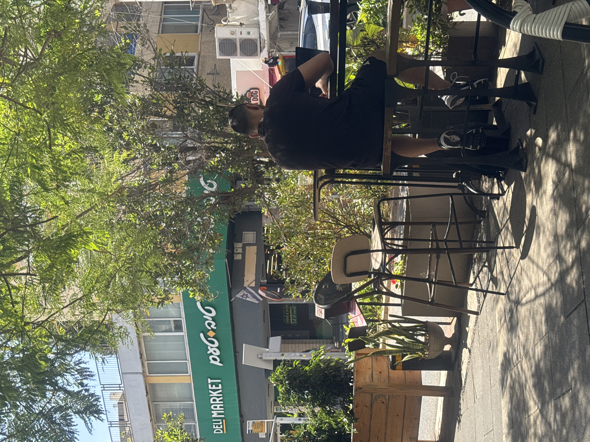 Morning street life documented in Givatayim cafe district