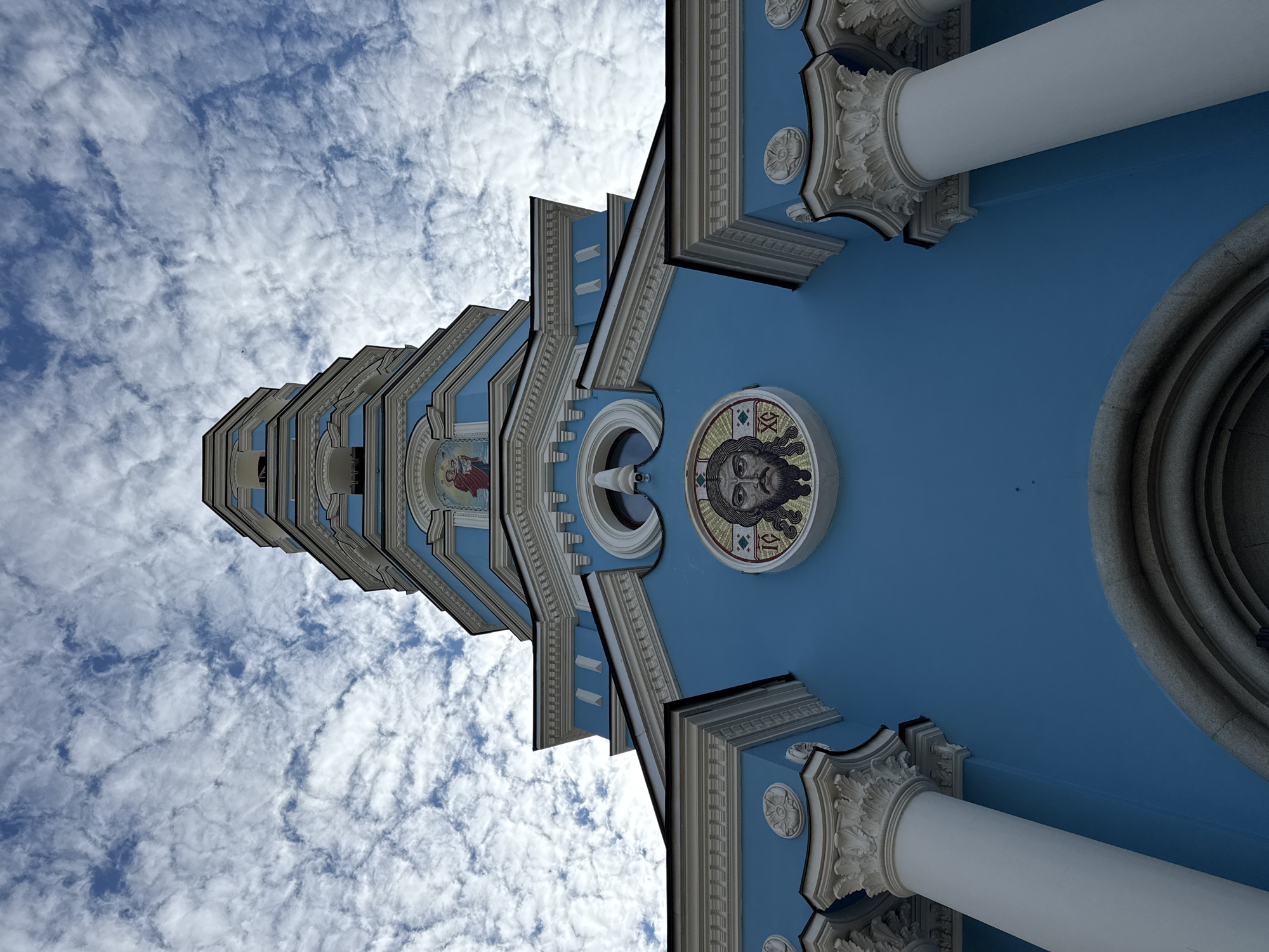 Orthodox church with blue architecture and golden domes photographed