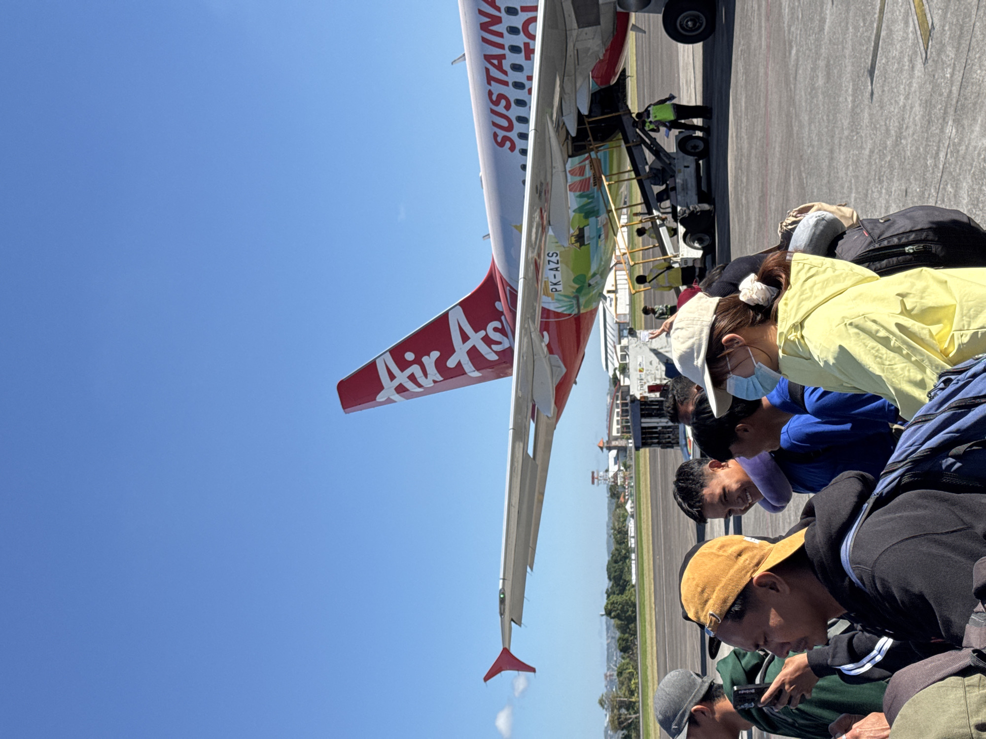Boarding time at Bali airport, AirAsia sustainable tourism livery on display