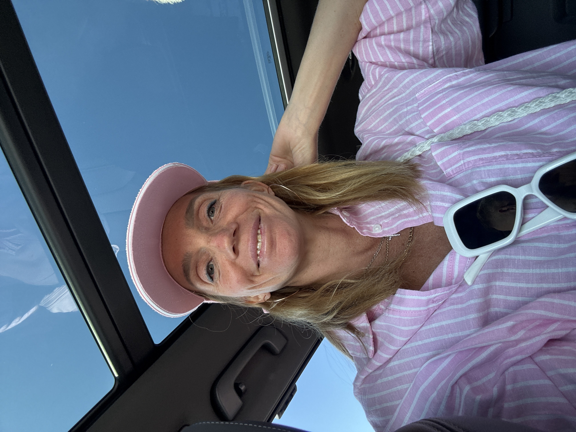 Woman takes selfie in car with sunroof in Kronstadt