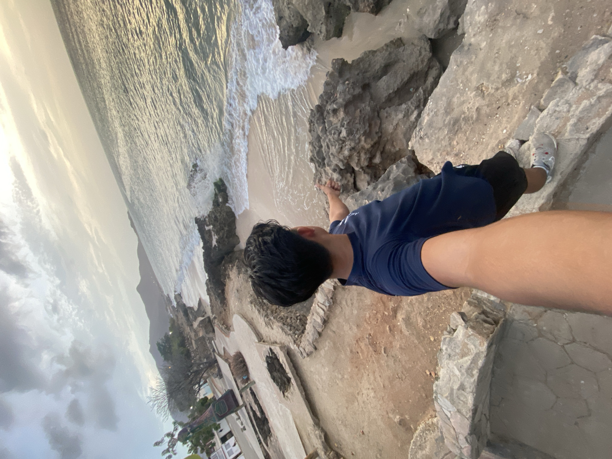Person observes sunset from cliffs in Juan Griego, Venezuela