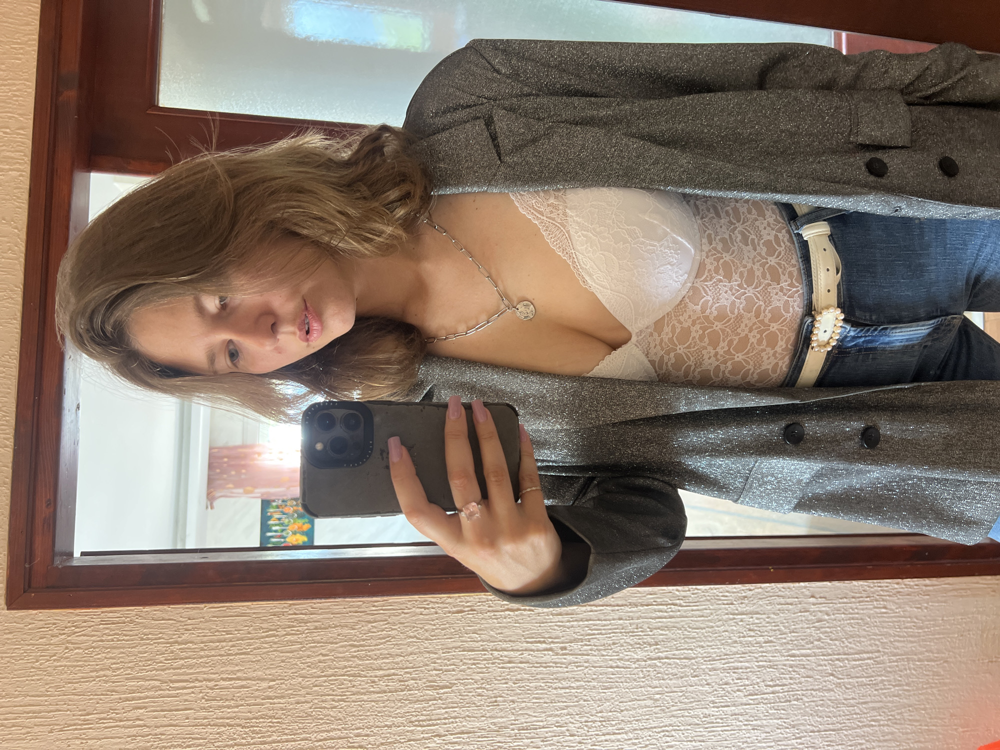 Woman takes mirror selfie in Podgorica room