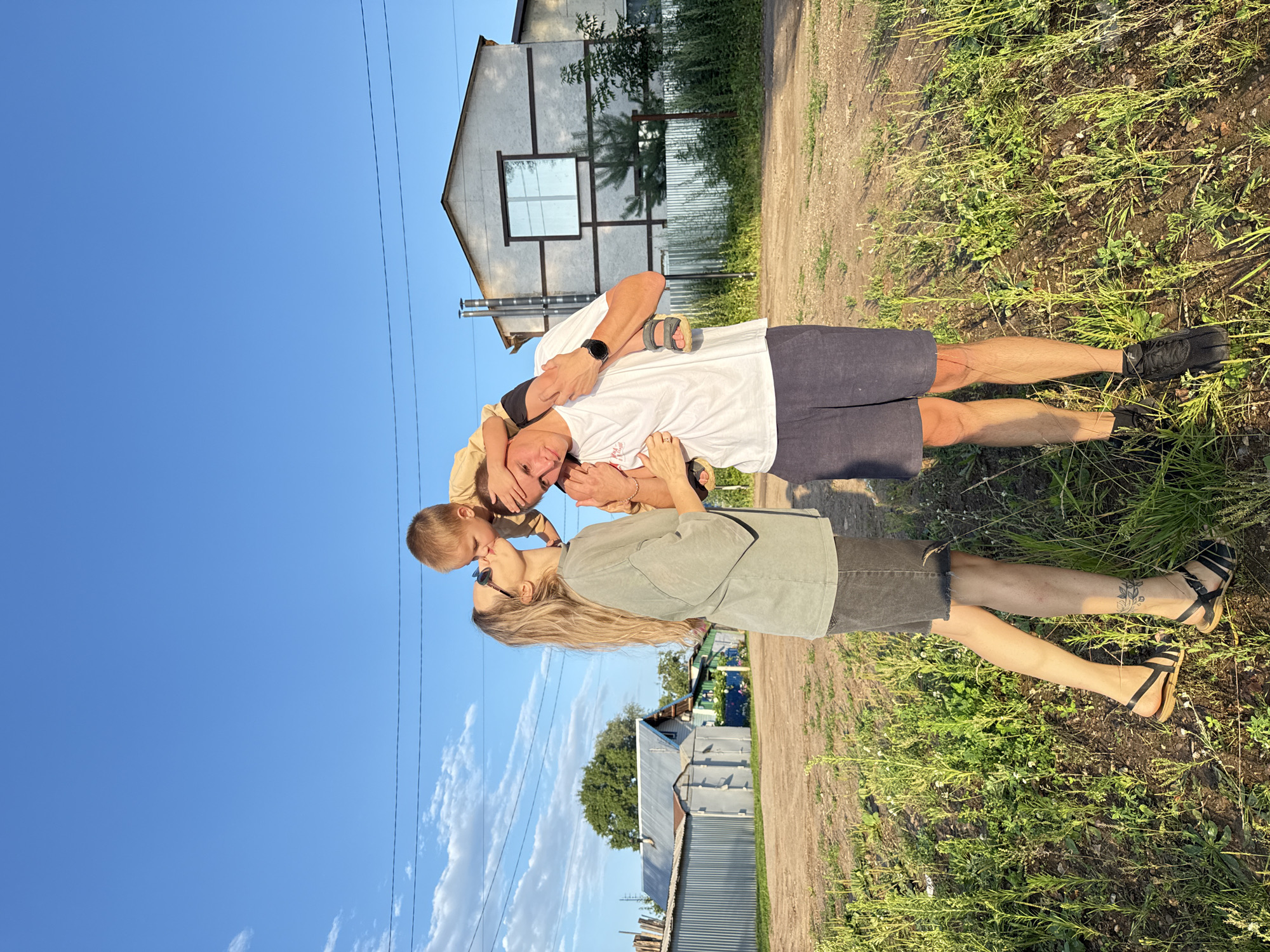 Affectionate family moment on a rural road near Chaikovsky