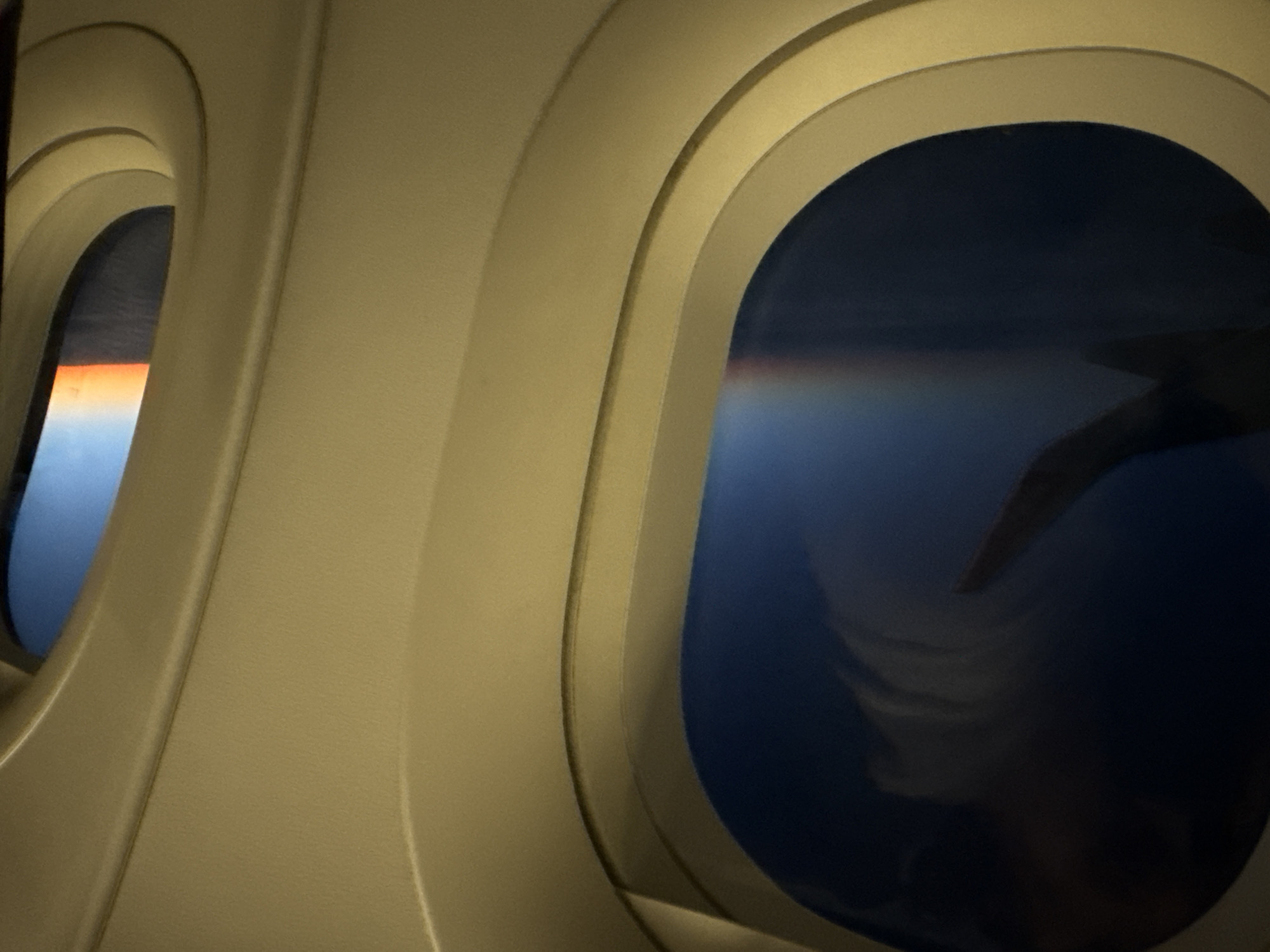 Passenger captures dual airplane window views over Balkans