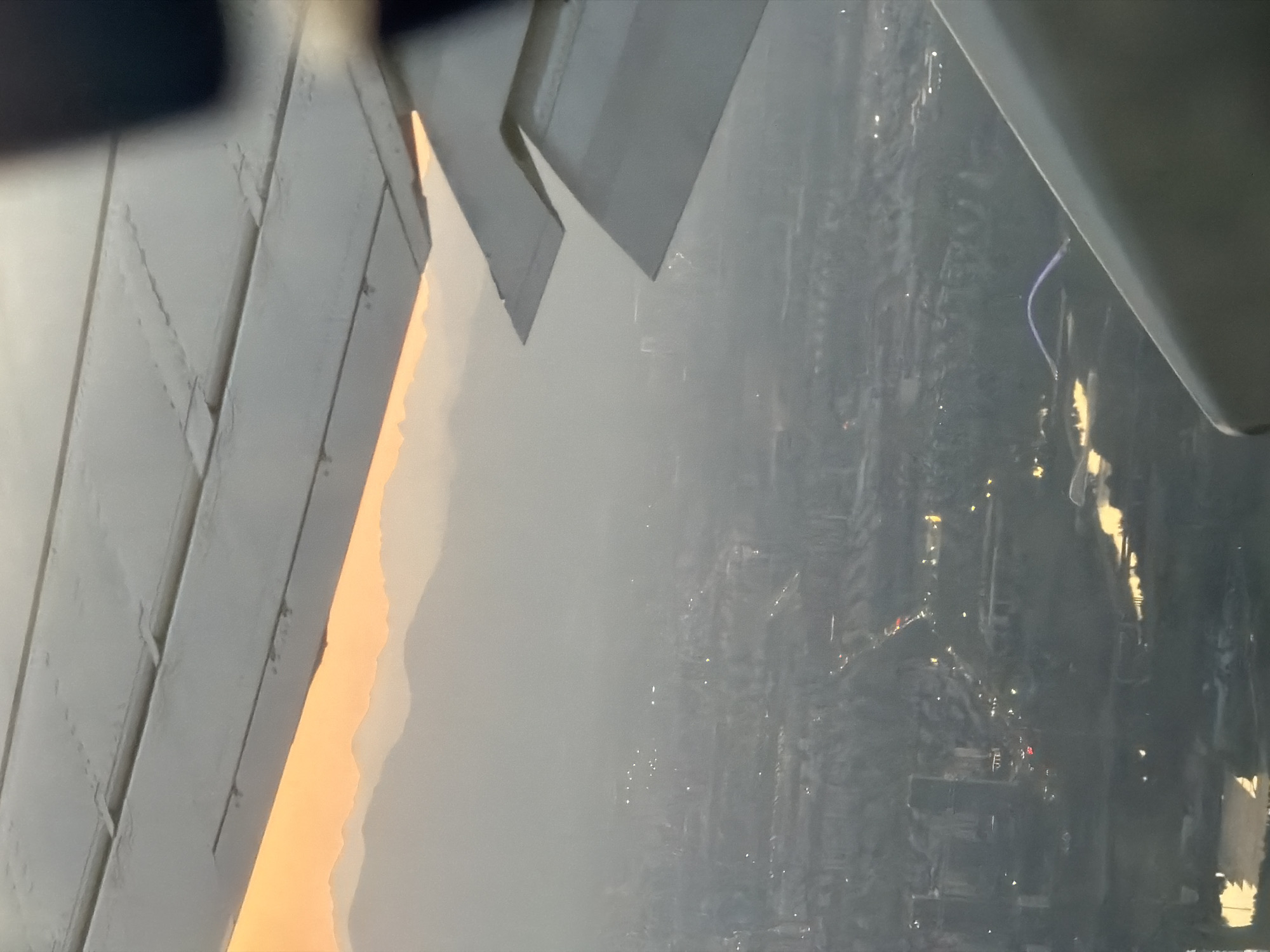 Passenger photographs airplane window view over Shunyi District