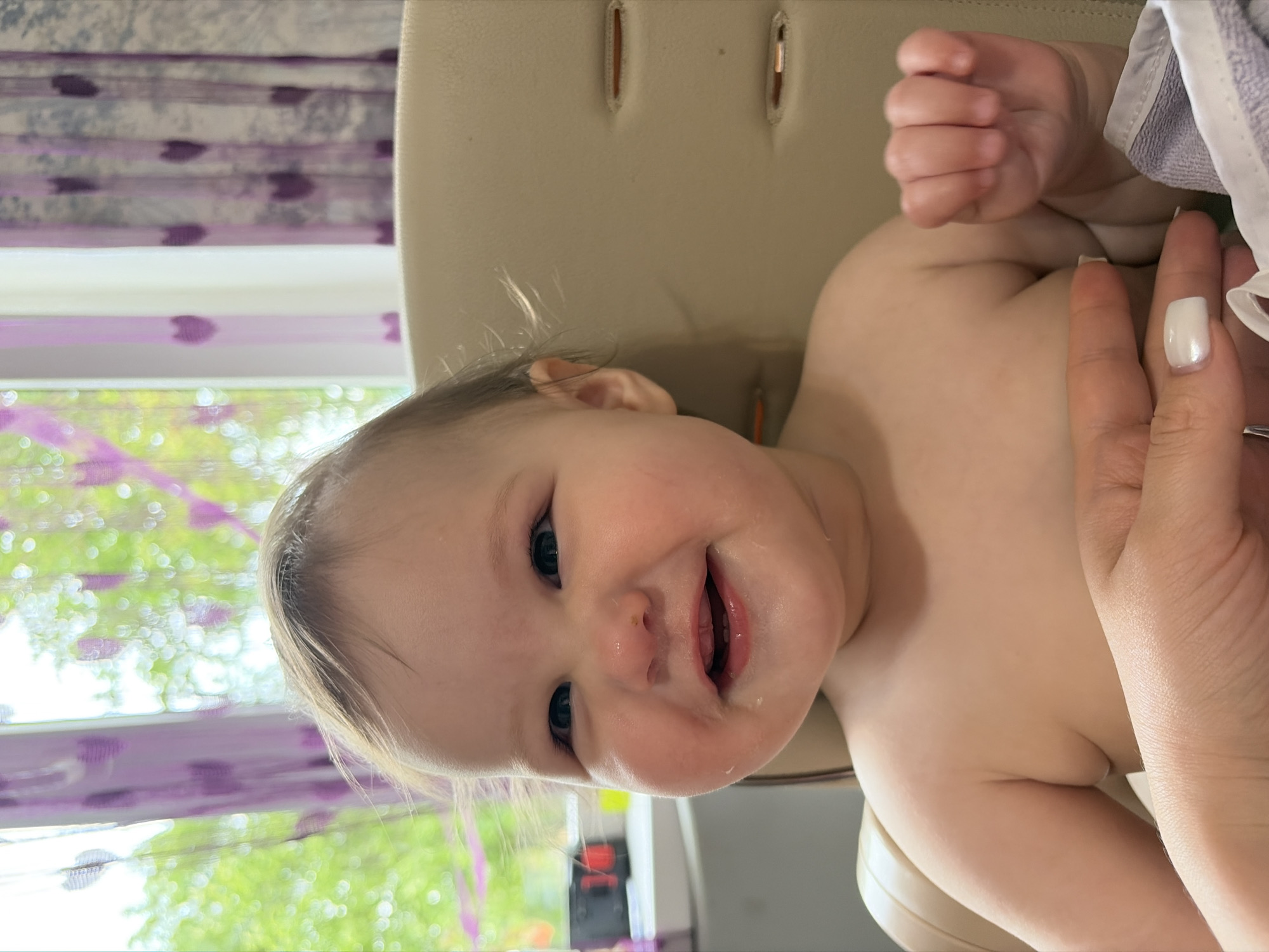 Baby's playtime documented in Novopokrovskaya home setting