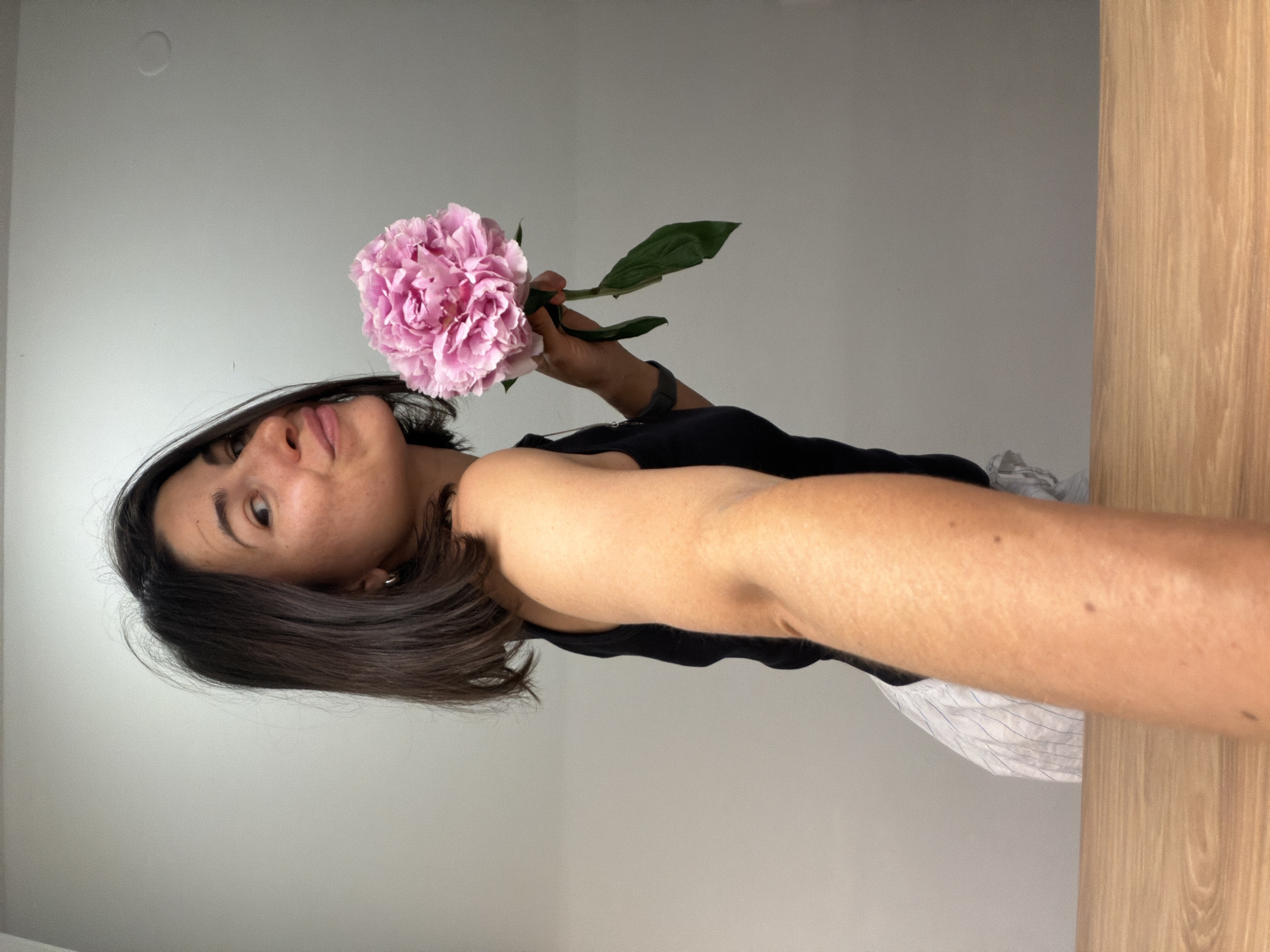 Woman poses with pink peony flower in Budva photo session