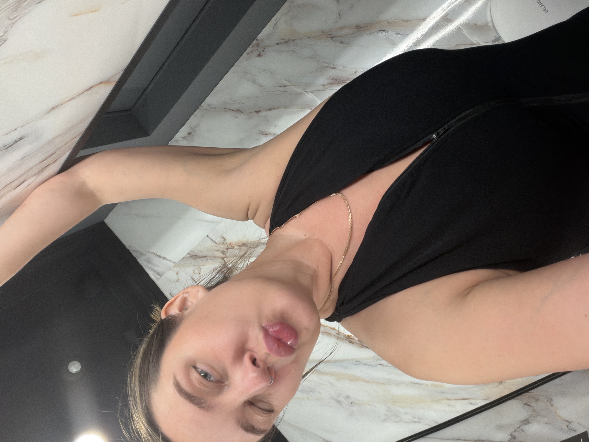 Woman records selfies in Moscow bathroom, winks at camera