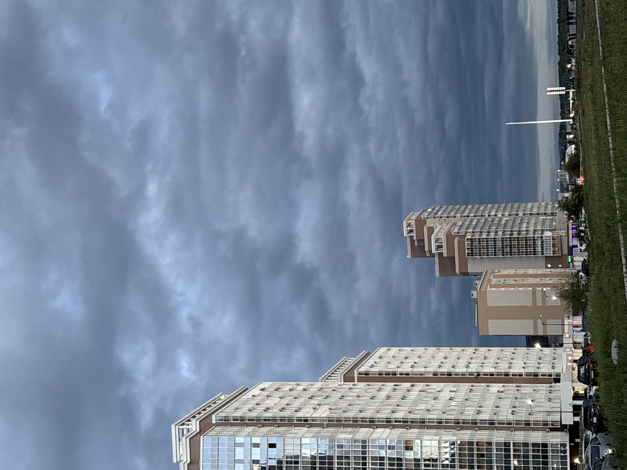 Glass high-rises stand out against a stormy sky