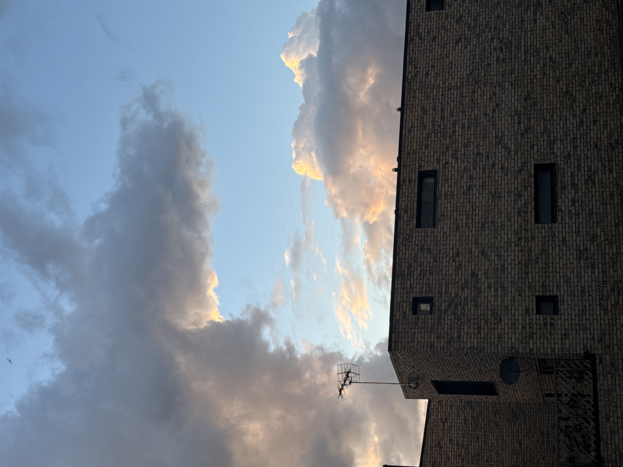 London brick building observed against cloudy evening sky