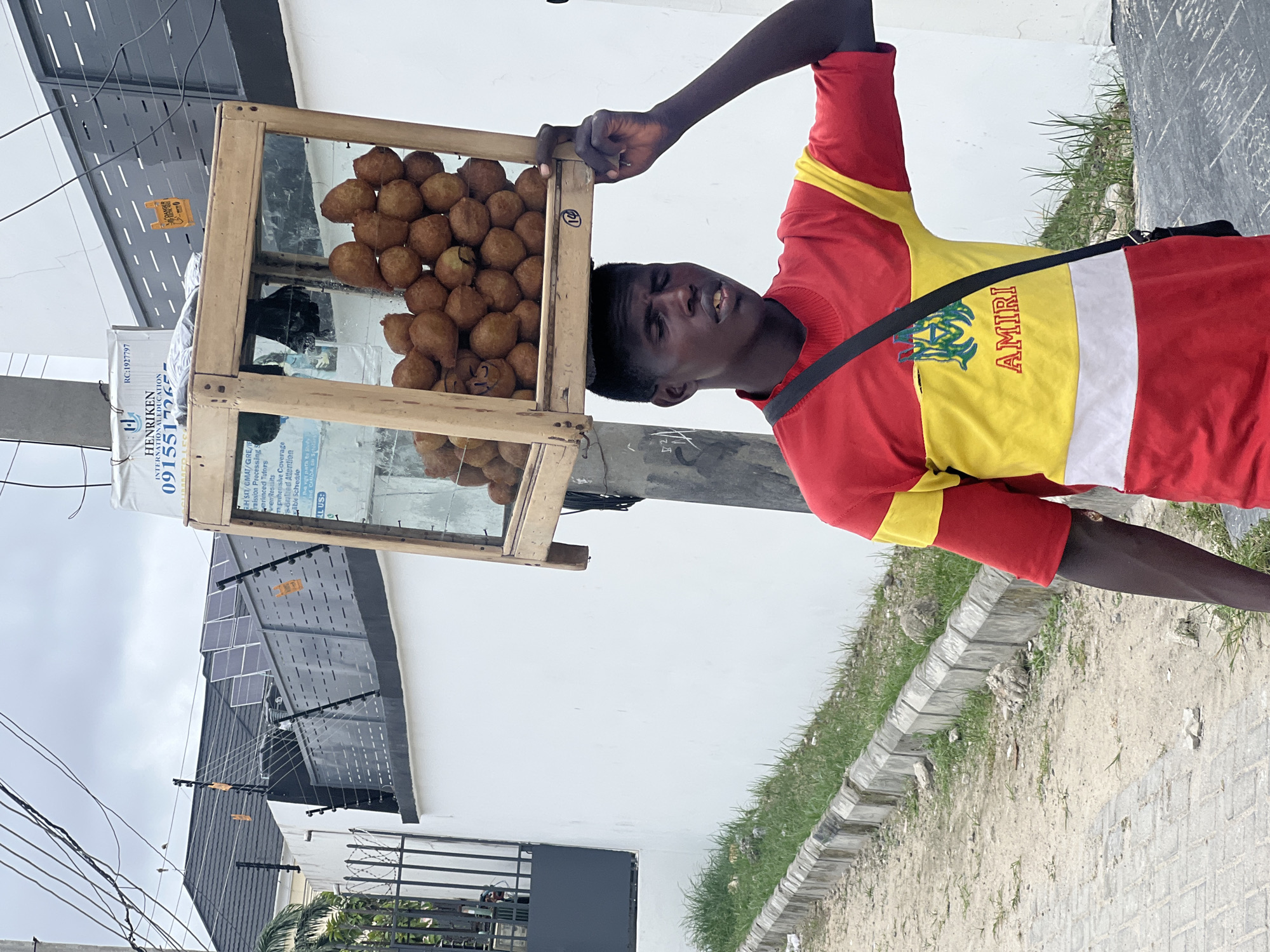 Street vendor sells fried dough balls in Igboefon, Nigeria