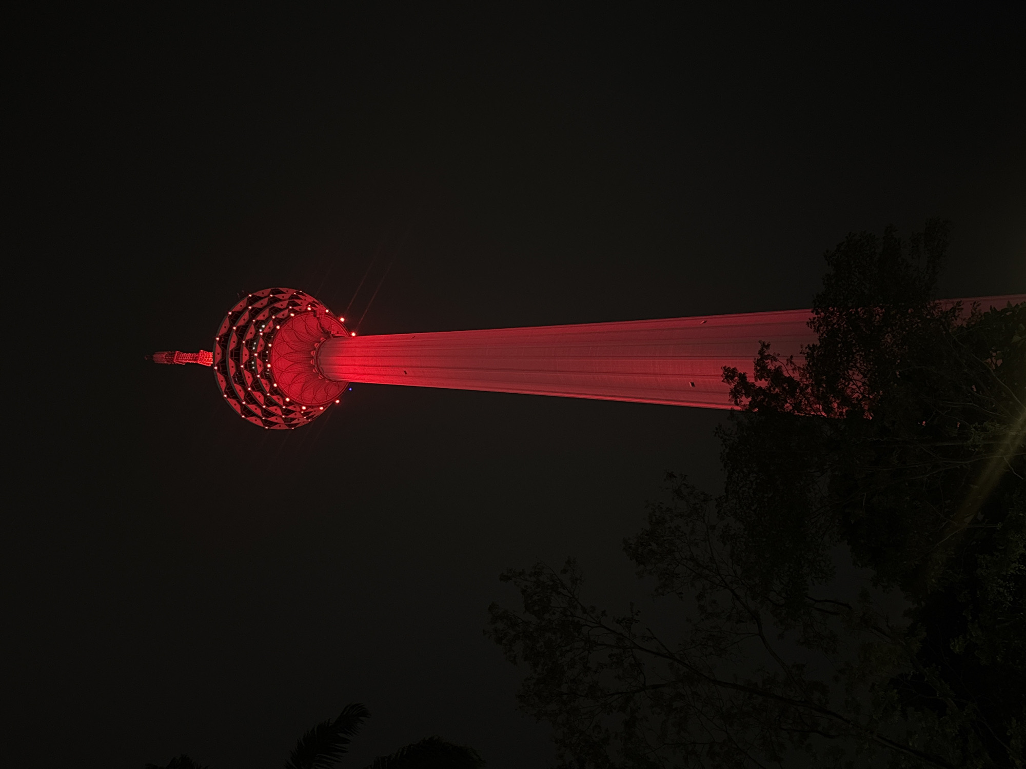 KL Tower glows red in Kuala Lumpur night sky