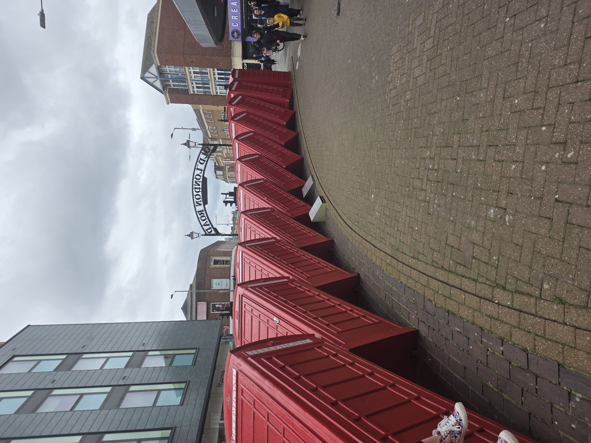 Red phone booths line Old London Road street
